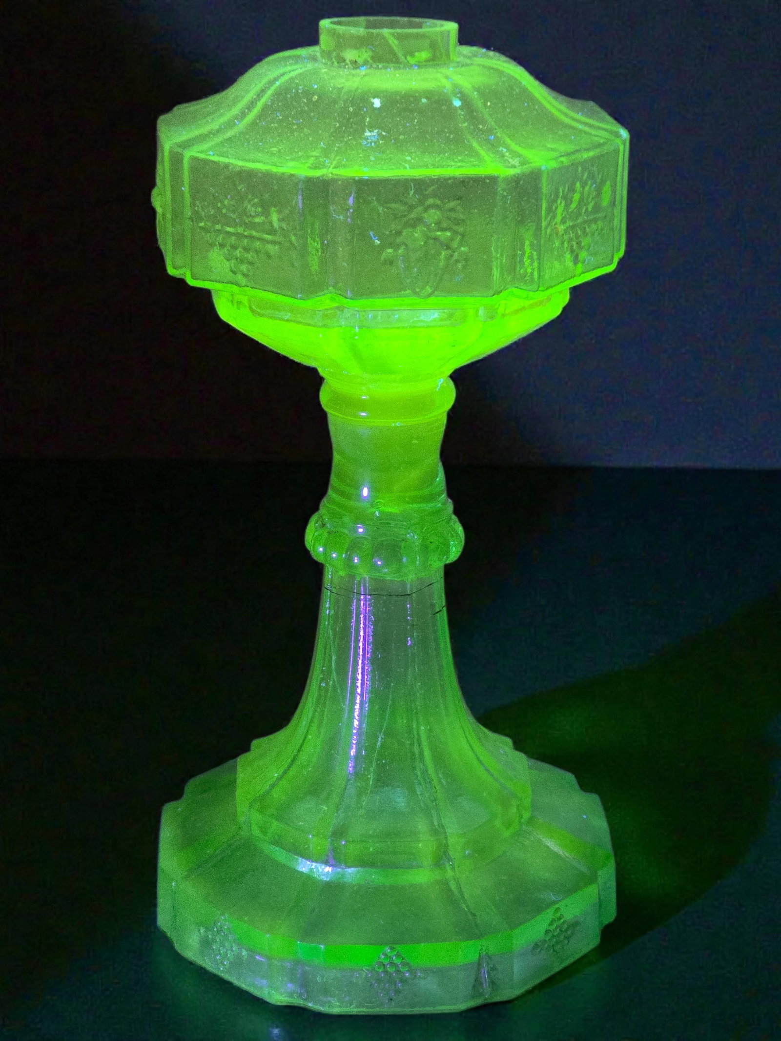 Early Pressed Uranium Glass Oil Lamp: The lamp is in good overall antique condition, with no notable major damage or flaws observed. Some small chips or minor defects may be present, as expected for an antique. The glass is uranium glass 