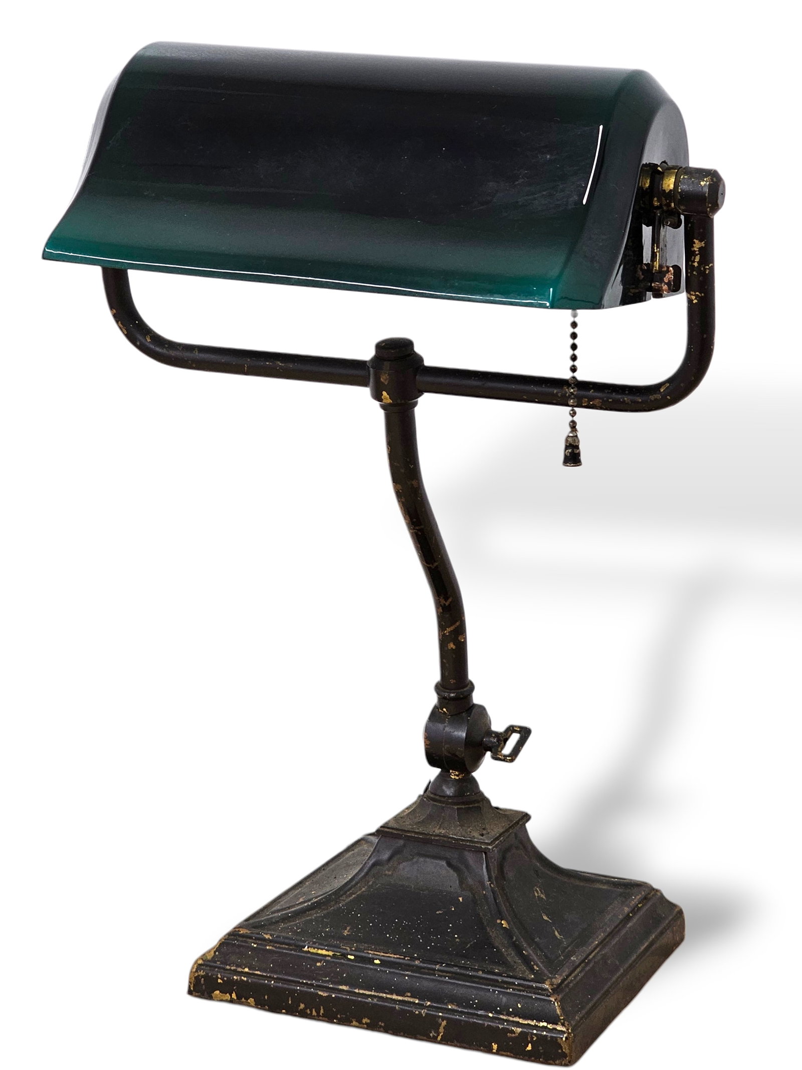 Early 20th C. Emeralite Bankers Desk Lamp: The lamp features the signature deep green glass shade and retains a partial original manufacturer's label on the interior. The base is solid and appears to retain its original finish, showing expecte