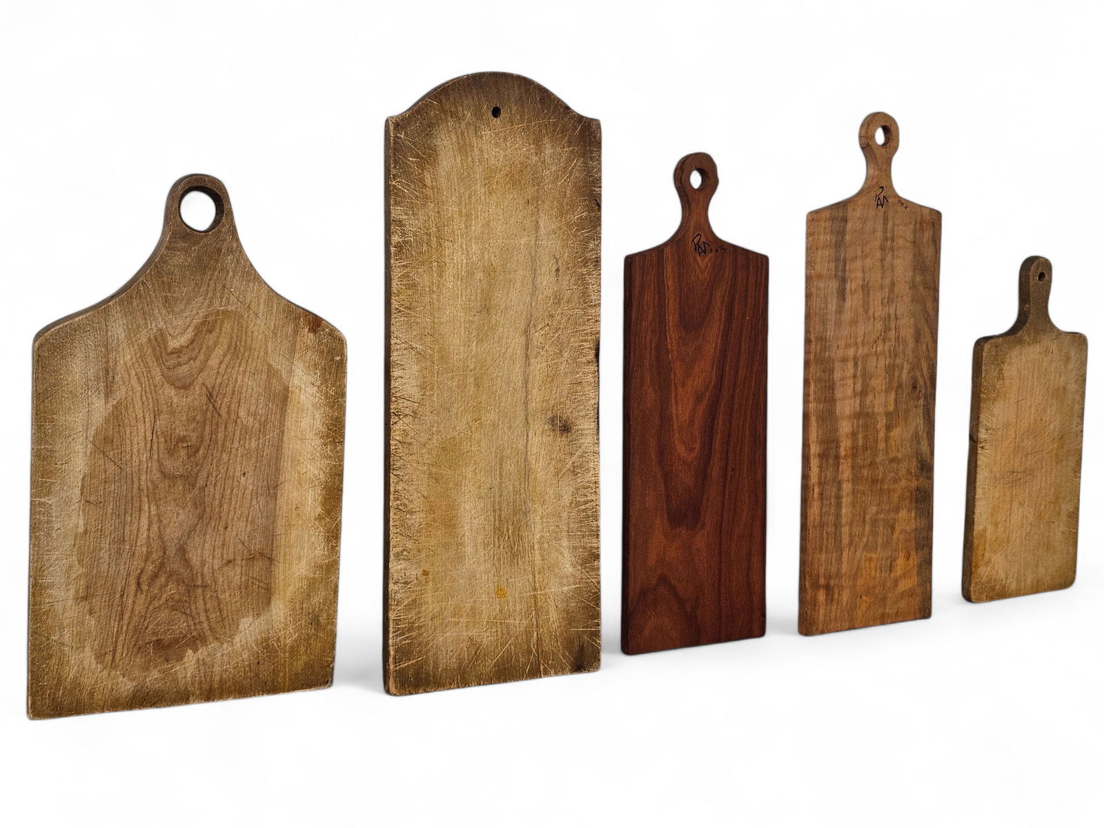 (5pc) Wooden Cutting Boards: 5 wood cutting boards of various sizes and styles. One signed near handle with an unknown signature. Wear consistent with use including some with heavy surface wear and knife marks. See photos for mor