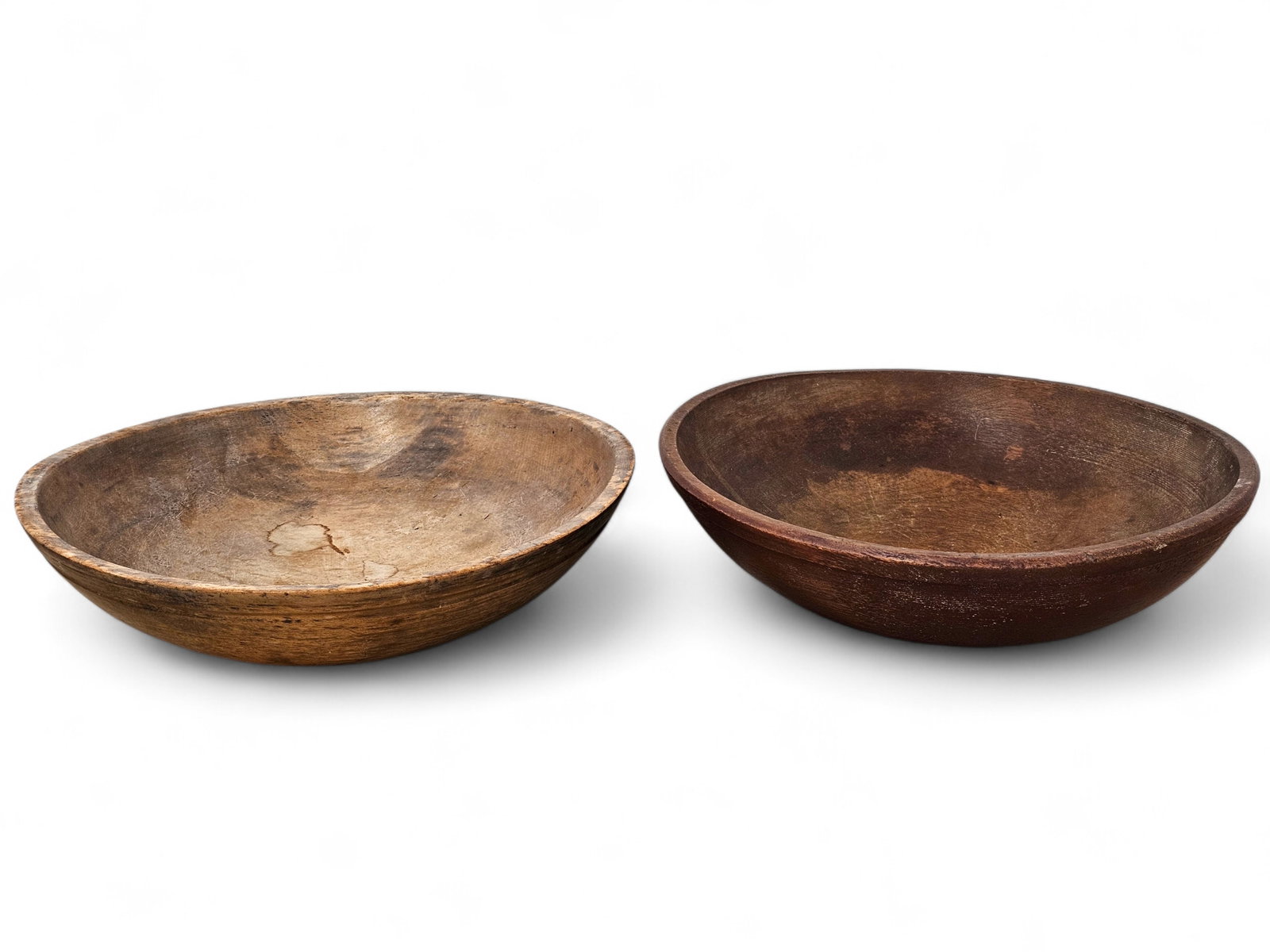 Pair of Turned Treenware Bowls: Two round treenware bowls, both likely made in 19th C. Wear consistent with age and use including surface wear and fading. See photos for more item and condition details. Measurements: 16" D
