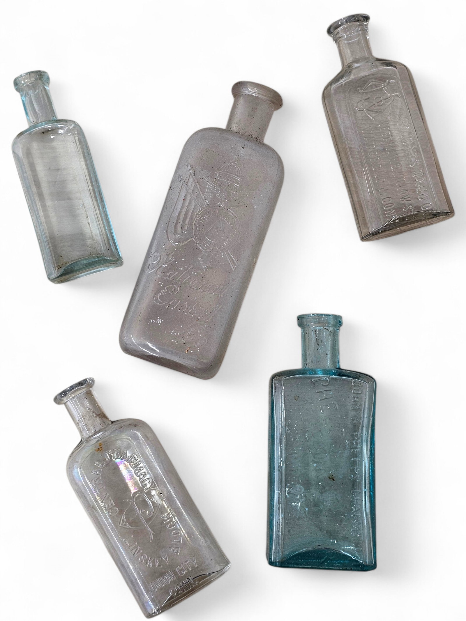 Collection of Antique Medical Bottles - Embalming Fluid & More: This lot includes a small, estate-found collection of bottles, all of which appear to be early medical bottles, and related examples. You will receive everything shown in the photos. Most bottles appe