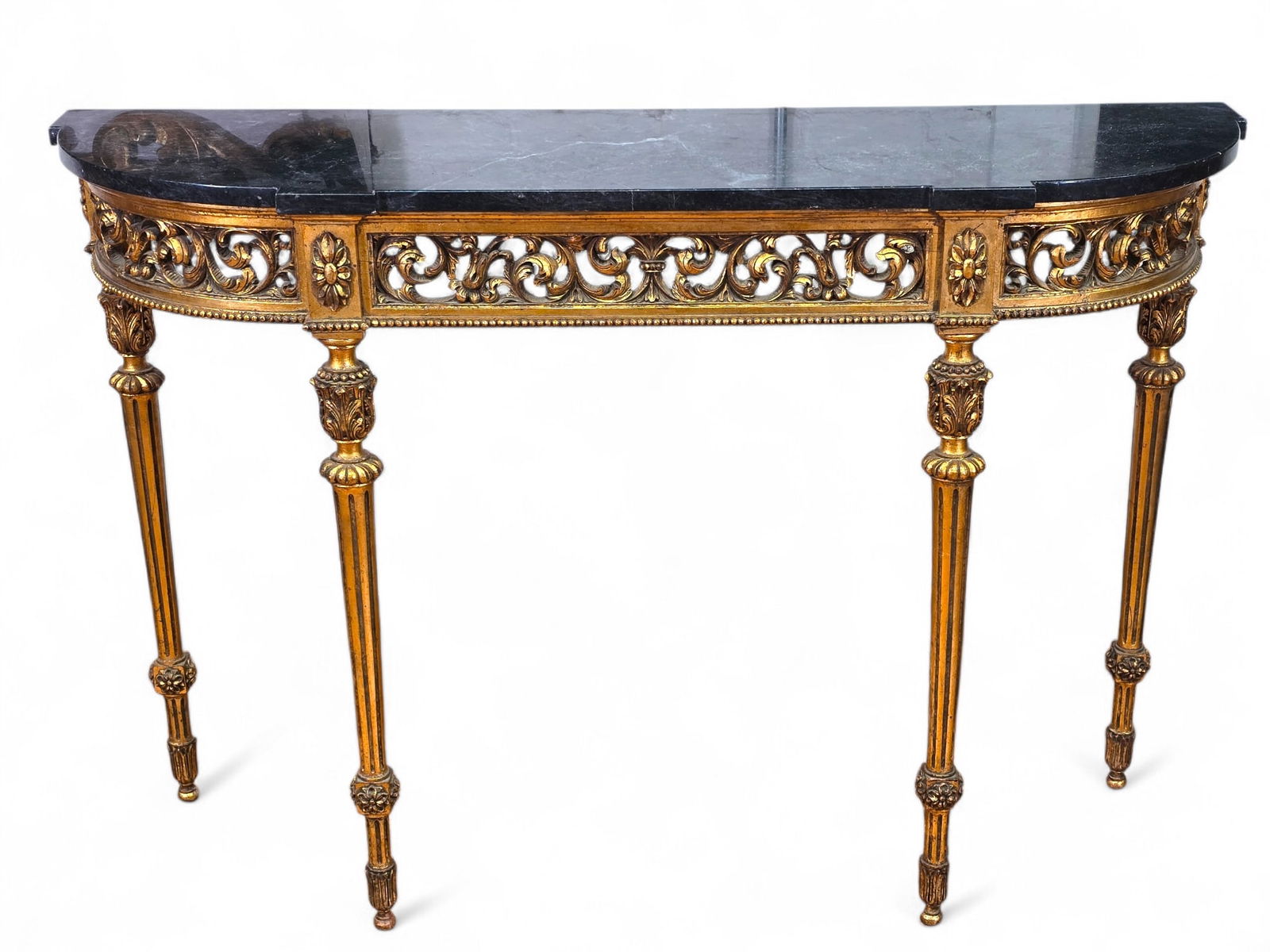 Rococo Style Carved Giltwood Marble Top Console Table:  Ornate Rococo-style gilt wood demilune console table with removable black marble top. Carved floral and scroll motifs on apron and base with carved fluted legs. Wear consistent with age and use