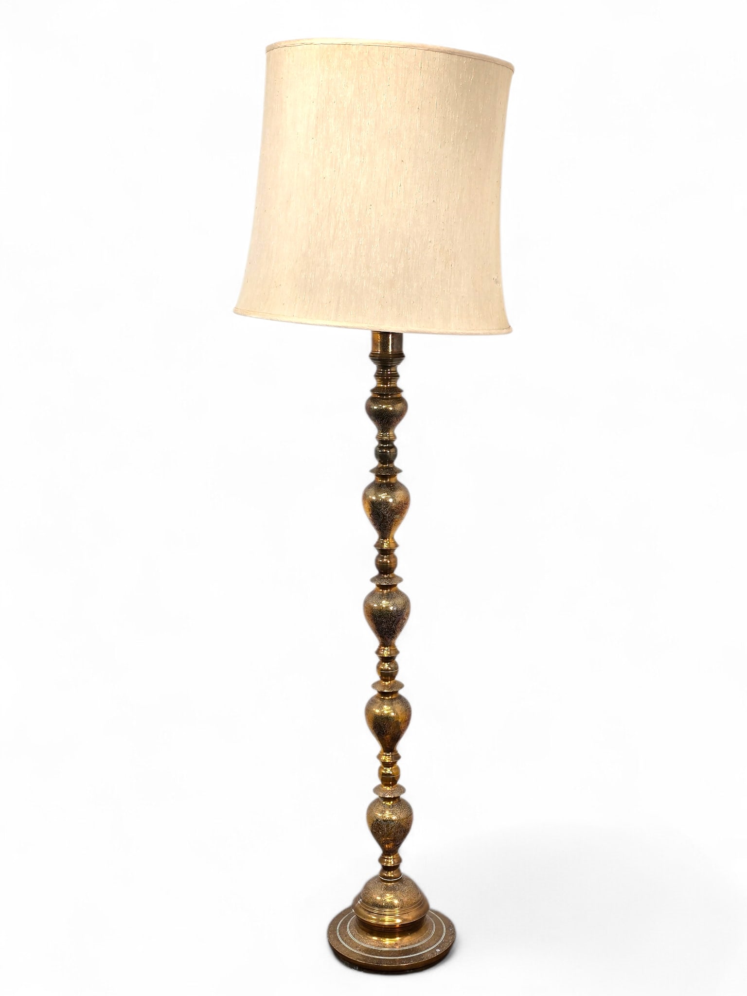 Large Indian Style Etched Brass Floor Lamp - 74.5" T:  Beautiful brass floor lamp with ornate etched designs. The lamp has a single socket and a large fabric shade. Wear consistent with age and use including surface wear, dings and dents, along wit