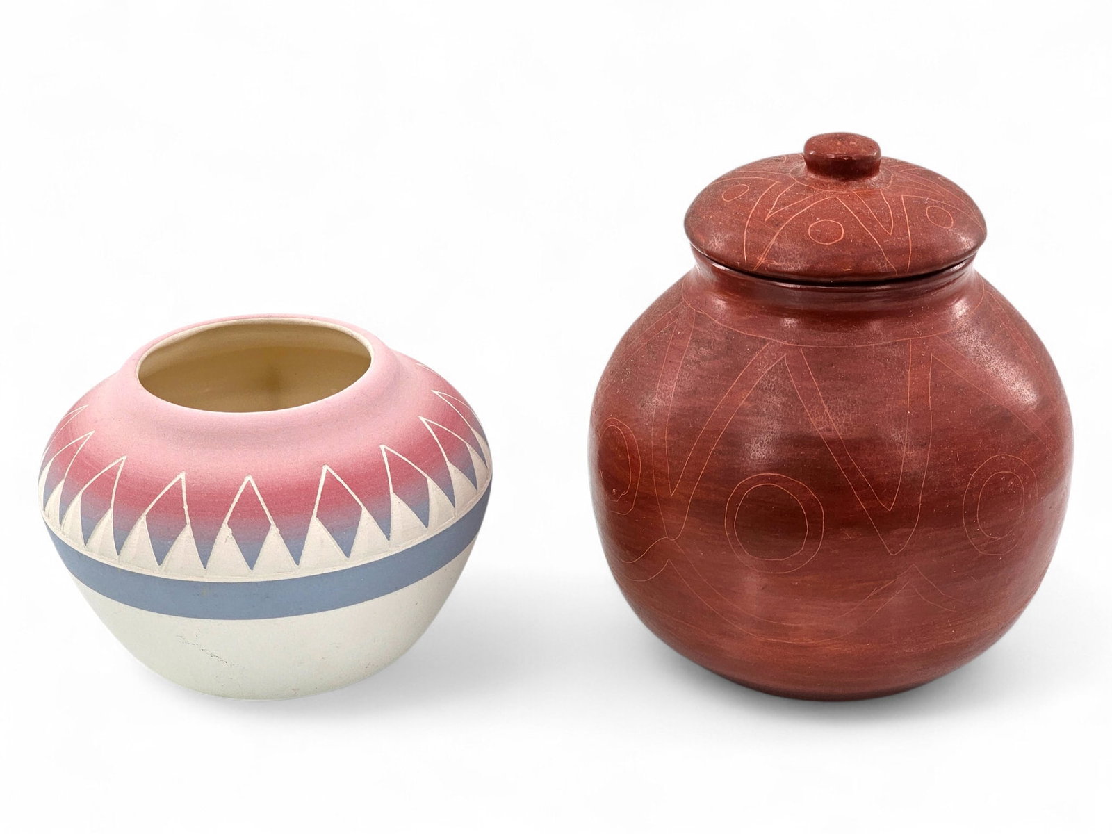 Pair of Native American Pottery Vessels: Pair of hand painted Native American pottery vessels, one being a Sioux piece painted with a gradient design and signed on underside. Other is unmarked/unsigned. Wear consistent with age and use inclu