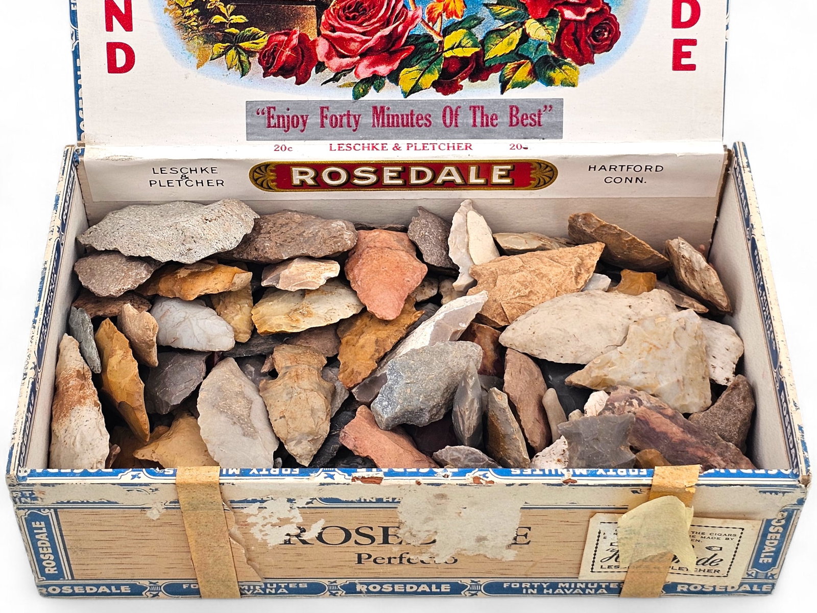 Bulk Lot of Native American Stone Arrowheads: Bulk lot grouping of Native American Stone arrowheads in a cigar box. The arrowheads are of various shapes, sizes, ages, and materials. See photos for more details on the contents of this lot. 