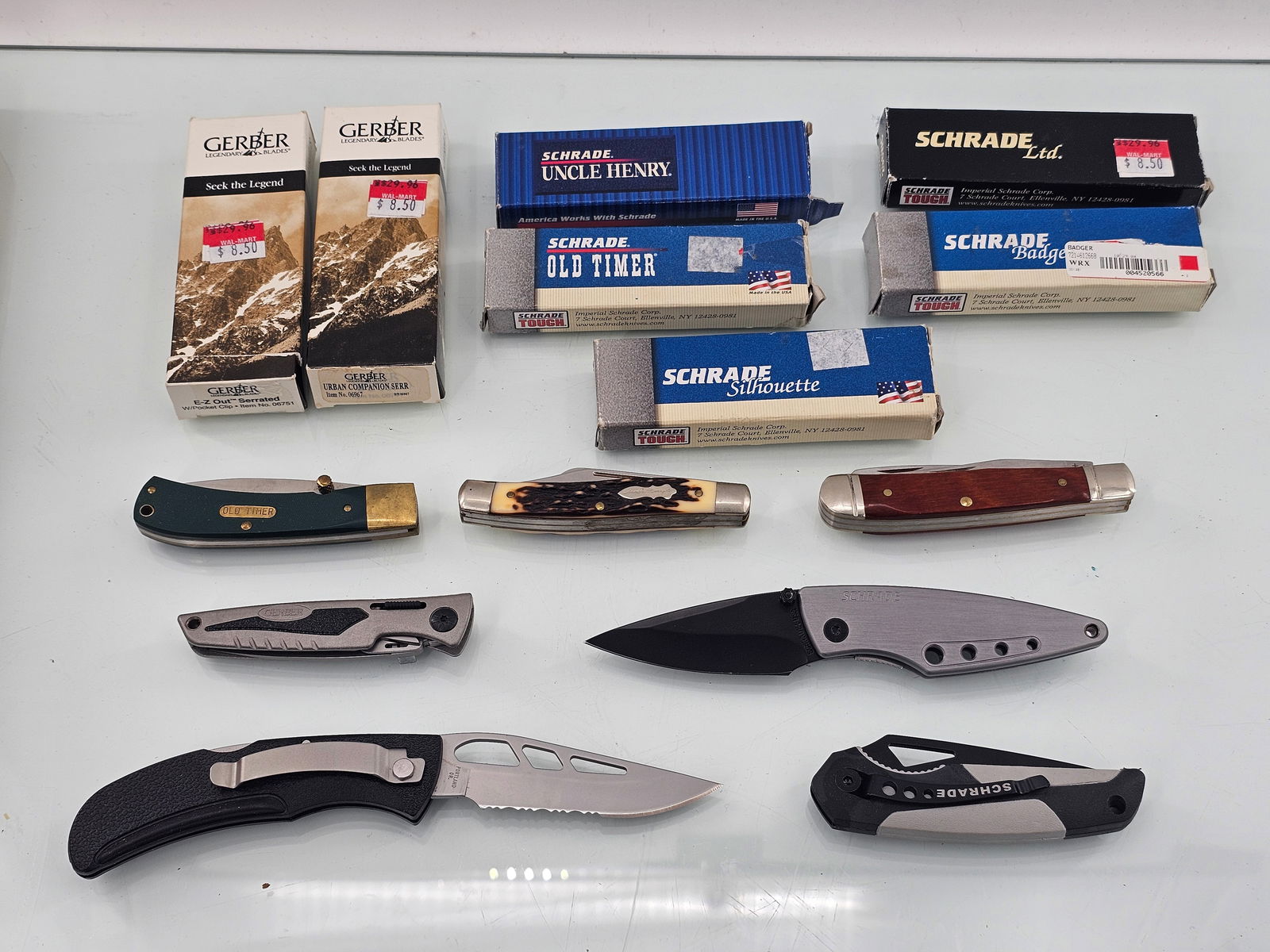 (7pc) Schrade & Gerber Folding Knives in Original Boxes: This lot includes a total of 7 knives some by Schrade & some by Gerber, all in their original pacakging. Some knives include the Schrade Old timer Gerber Urban Companion, and more. Most appear to be n