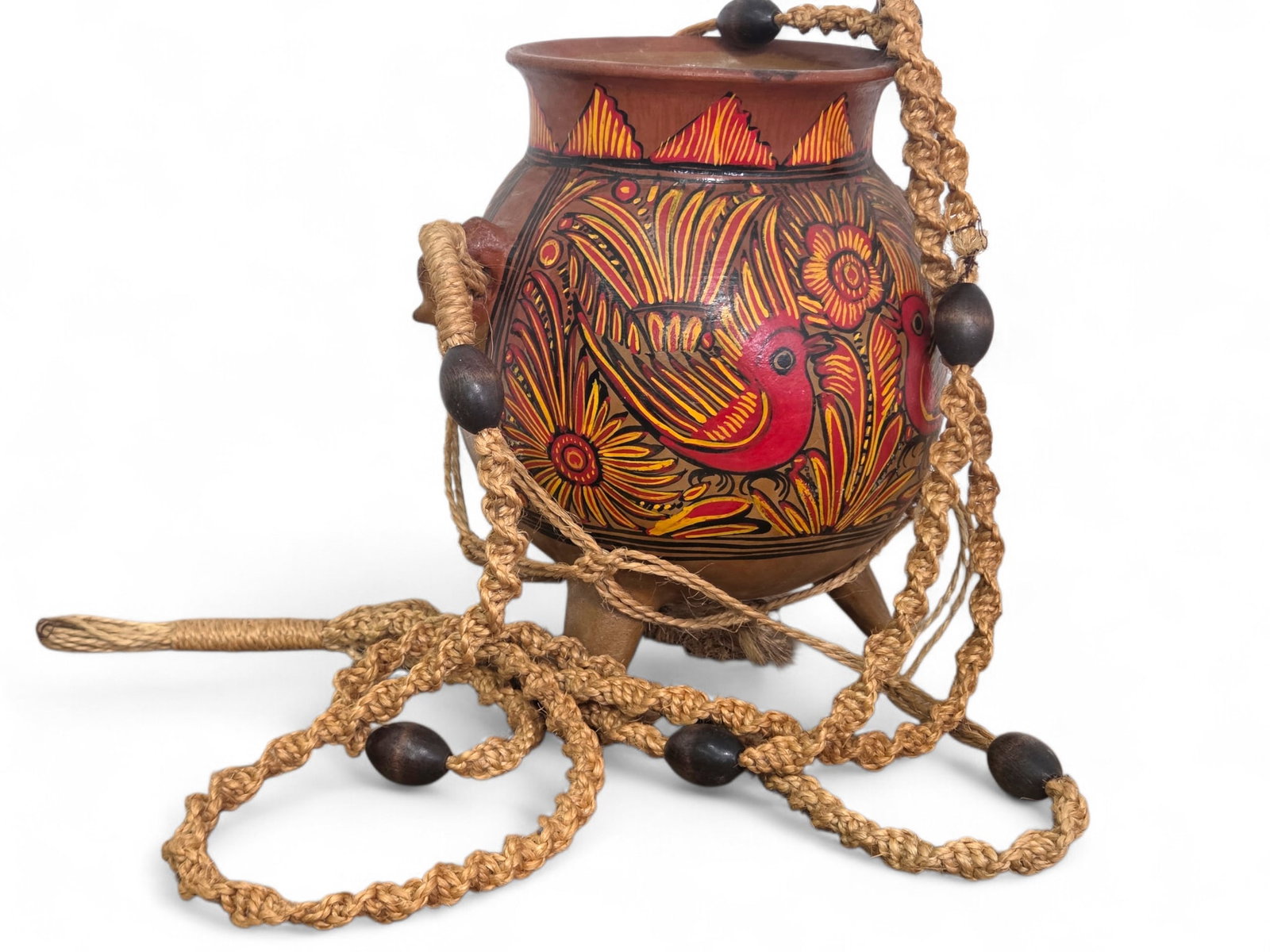 Mexican Folk Art Terracotta Hanging Bowl: Mexican folk art terracotta pottery tri-foot bowl with rope for hanging. The bowl has hand painted colorful birds and foliage. In overall good condition with expected wear consistent with age and use.