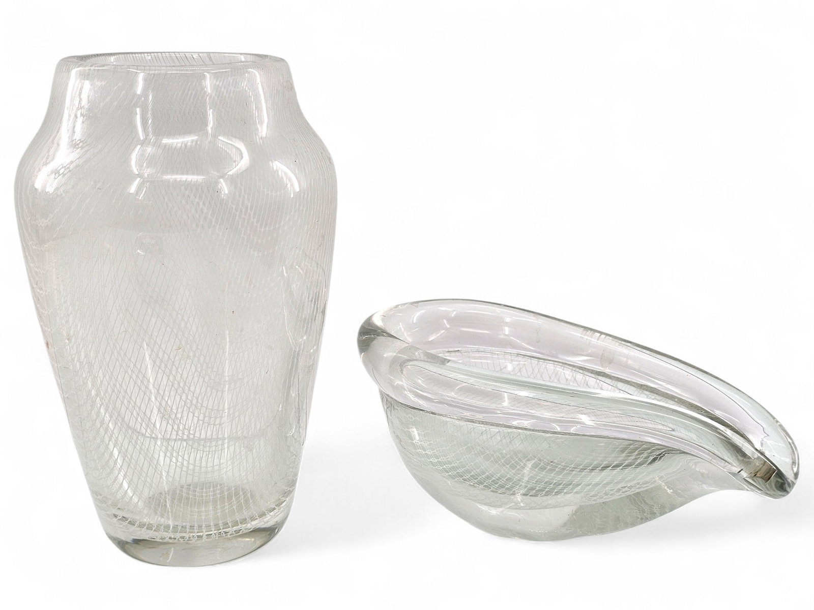 Pair of Latticino Art Glass Vessels: This lot includes a vase and a tear drop shaped bowl/vessel. Both are clear glass with a white latticino lace pattern. Unsigned and unmarked. Wear consistent with age and use including surface wear an
