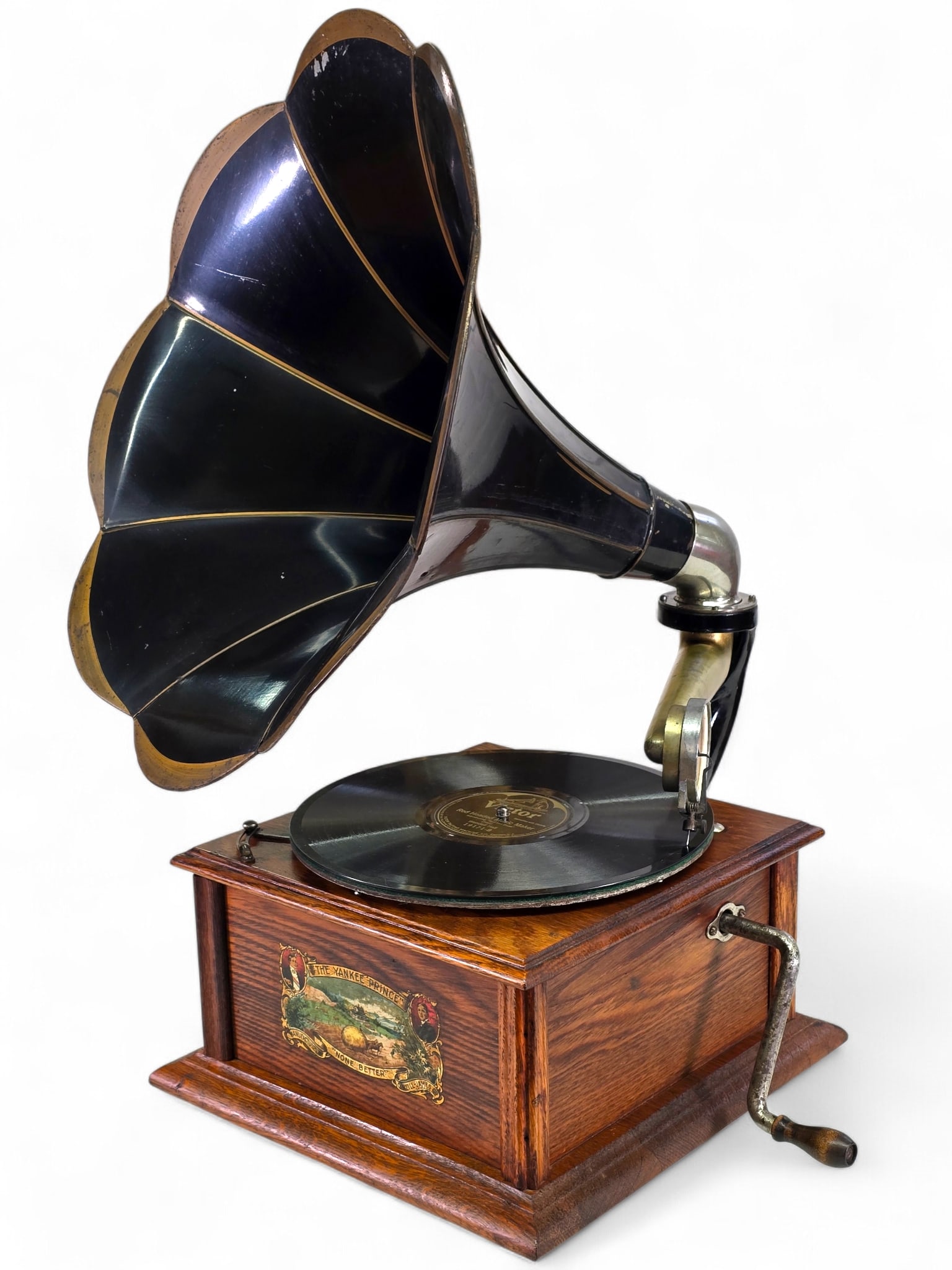 Antique O'Neill-James Co. "The Yankee Prince" Tabletop Phonograph: Antique cylinder phonograph housed in a polished oak case, retaining its original applied manufacturer’s label, the case is missing one of the edge trim pieces. The player includes its original horn