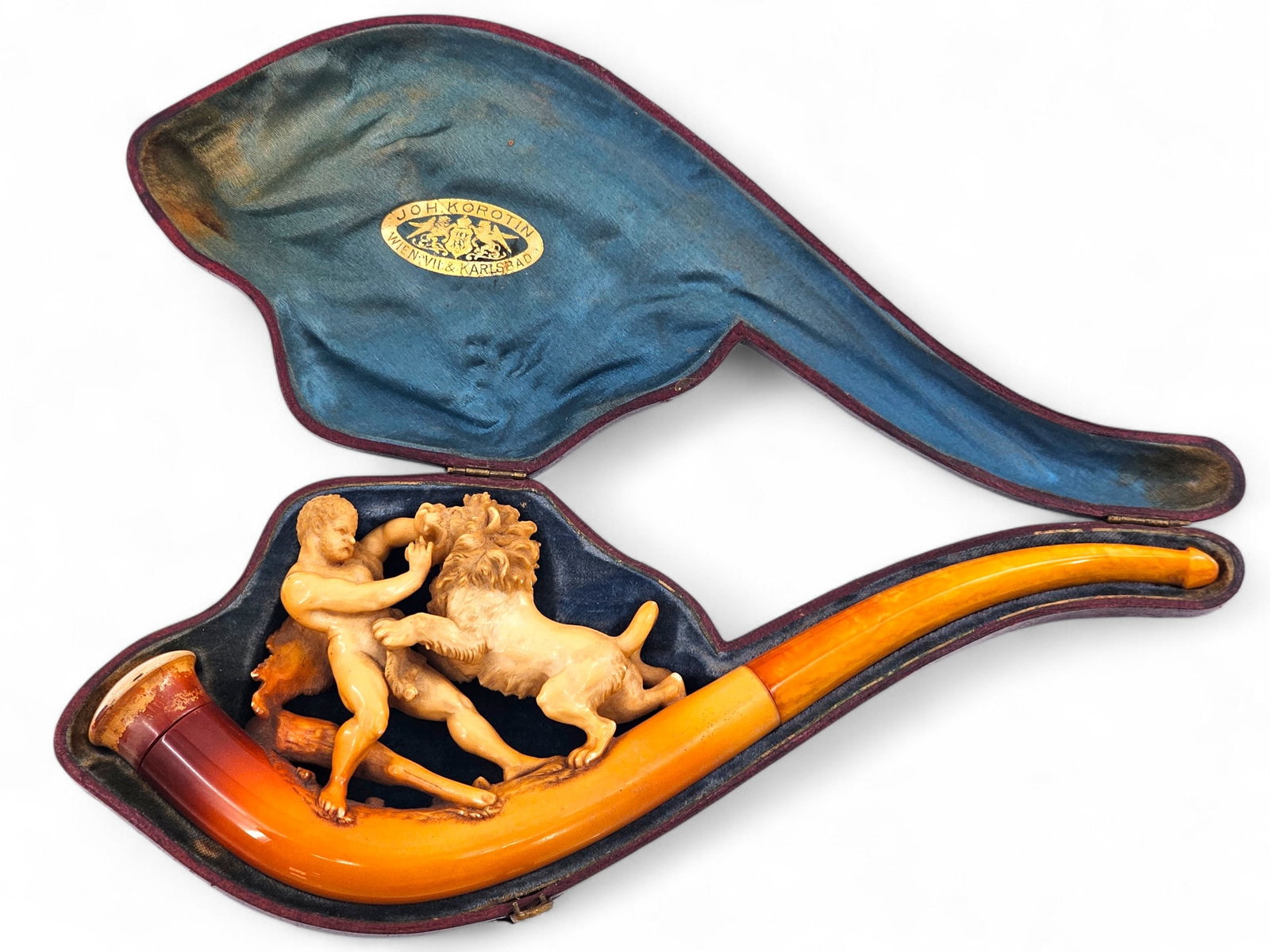 Intricately Carved 19th C. Hercules & Lion Carved Meerschaum Pipe: 19th C. meerschaum tobacco smoking pipe with a very finely carved man and lion fighting. Pipe is in a case and features a light amber color mouthpiece. Wear consistent with age and use including disco