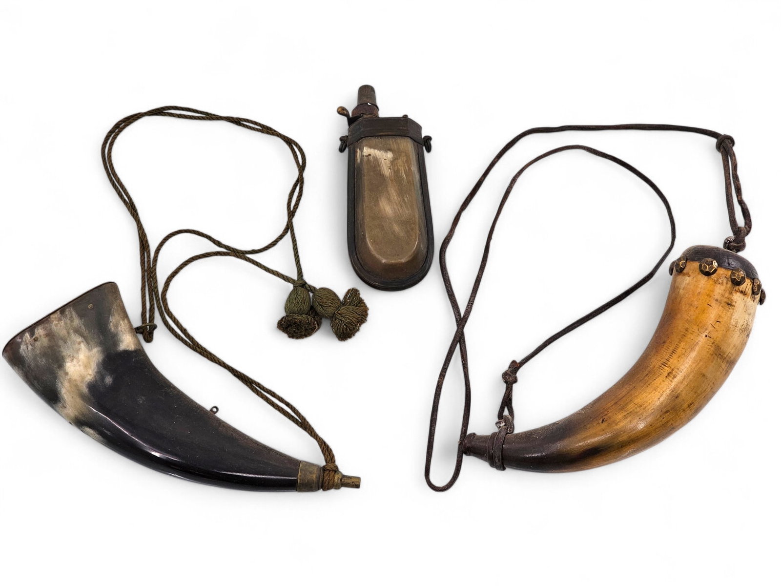(3) Antique Powder Horns & Shot Flasks: The powder flasks are offered in estate found condition, showing expected ware from general age and use. Each made from animal horn, and well crafted with brass fittings, one is in a very unusual shap