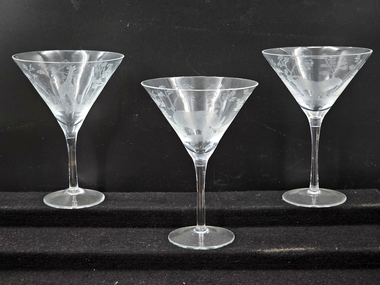 (3pc) Krause-Kristall Etched Martini Glasses w/ Safari Animals: This lot includes 3 crystal martini glasses by Krause-Kristall, crafted by hand in Fichtelburg Germany. The glasses are "Grainau" pattern and feature etched designs of safari animals and trees. The gl