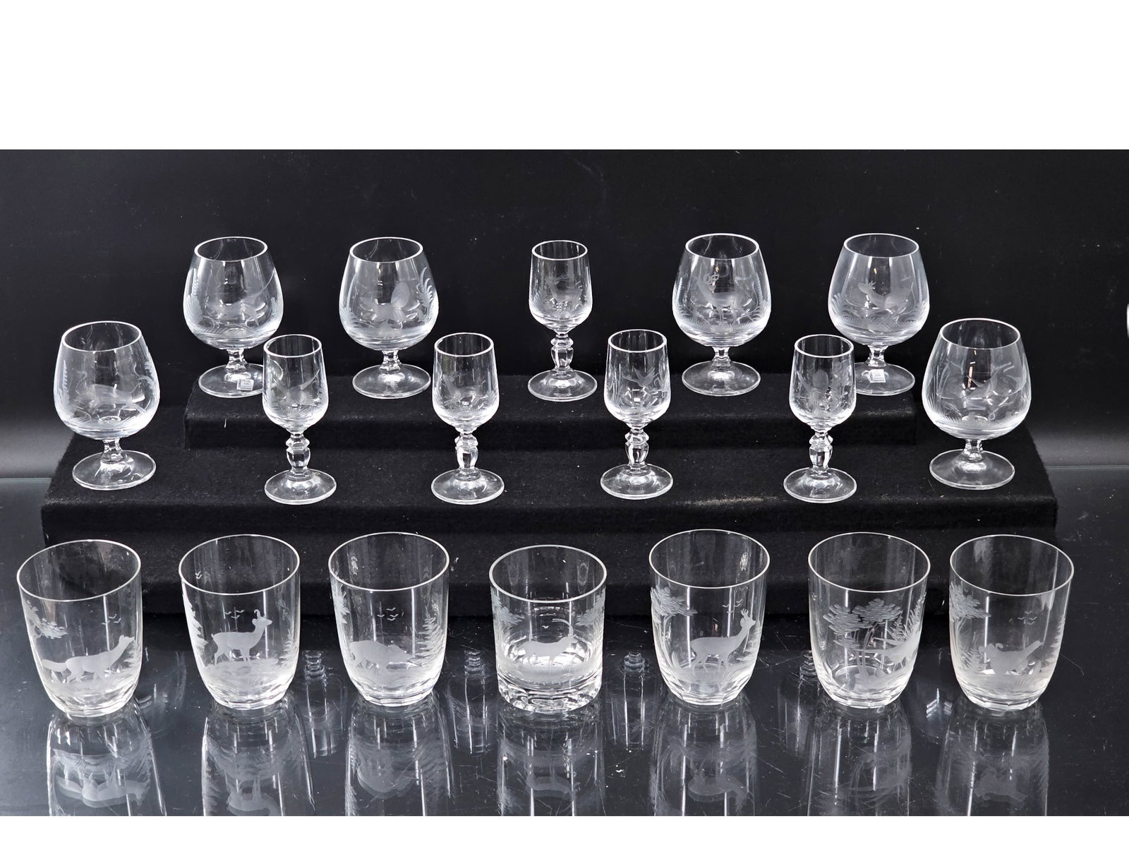 Large Grouping of Krause-Kristall Etched Stemware & Glasses: This lot includes 5 cordial glasses, 7 tumblers, and 6 brandy glasses, all by Krause-Kristall, crafted by hand in Fichtelburg Germany. The glasses are in the "Grainau" pattern and feature etched desig