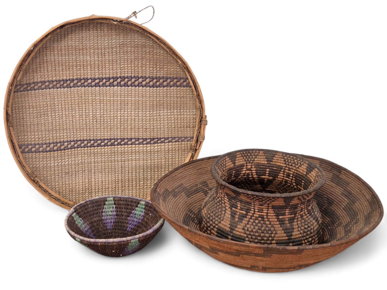 Grouping of 4 African Tribal Woven Baskets: Four African woven baskets of various sizes, patterns, & shapes. Wear consistent with age and use including some small breaks and loose weaving. See photos for more details and condition information.