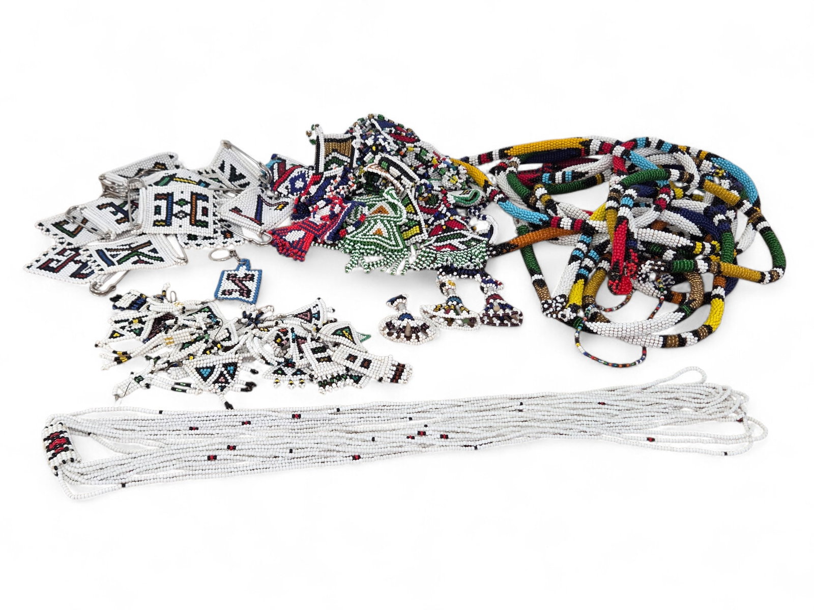 Collection of African Tribal Beadwork w/ Geometric Designs: Large collection of African beadwork including necklaces, pins, bracelets, and other decorative pieces. Many items have multi-colored geometric beaded designs. Wear consistent with age and use includi