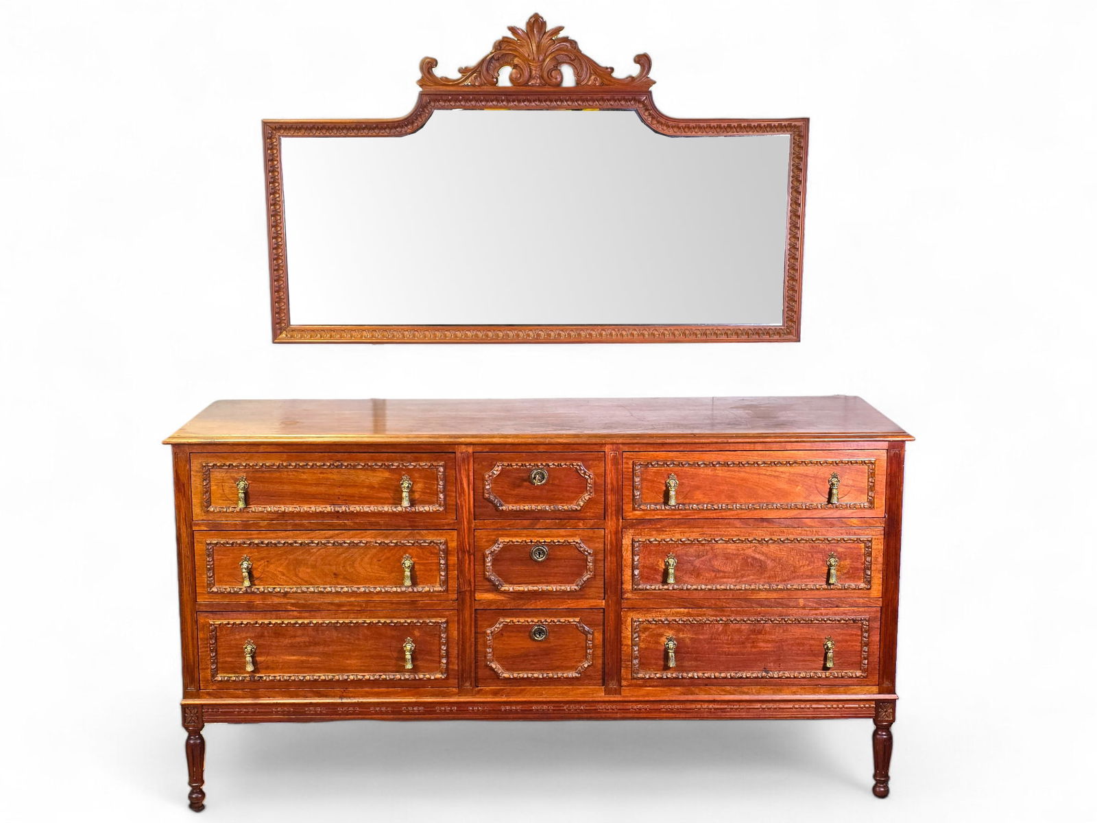 Antique Louis XVI Style Walnut Chest of Drawers / Dresser & Mirror: The dresser is in good overall used antique condition, showing finish ware as expected with age and use. Includes a matching wall hanging mirror. The piece is covered in applied wood carvings througho