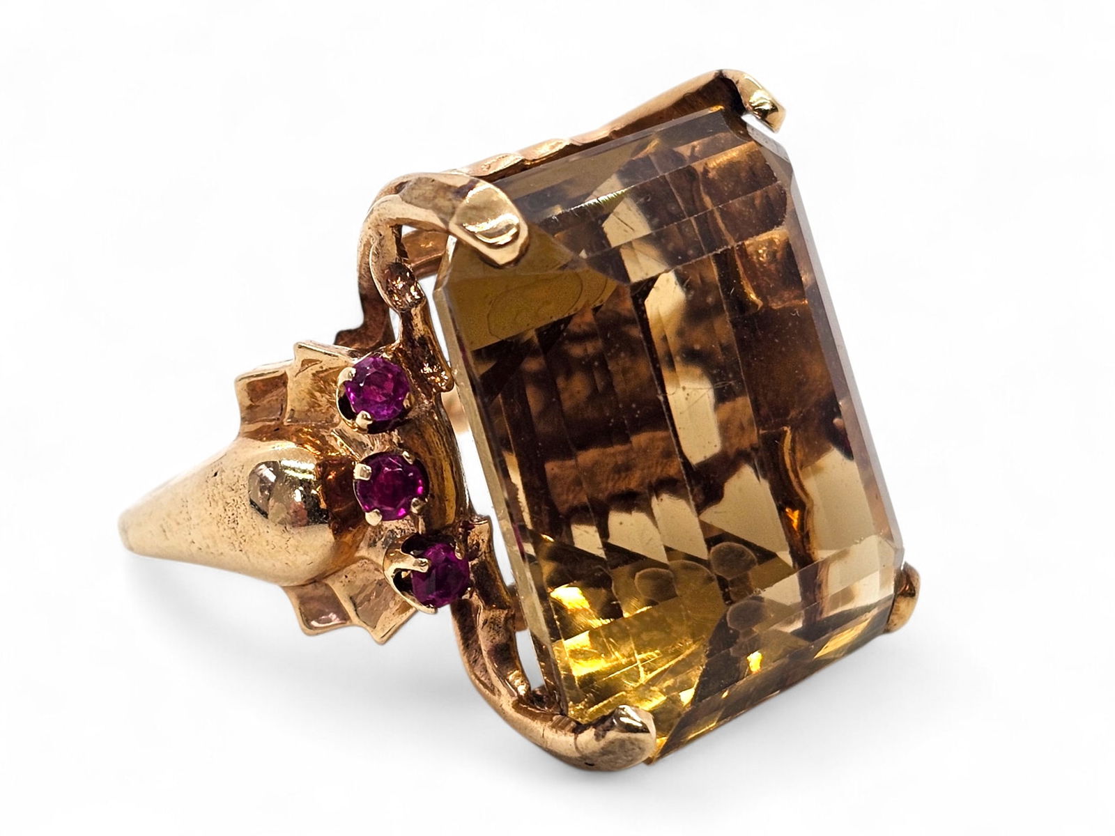 Large 14K Yellow Gold Citrine & Ruby Ring: Details: 14K yellow gold large citrine and ruby cocktail ring. Emerald cut citrine stone measuring 23 x 18mm. Flanked by 6 small rubies and set in a 14K yellow gold mounting. Appears vintage in age. U