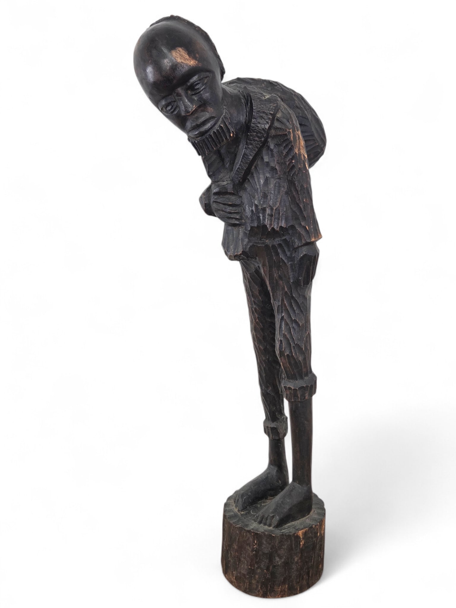Folk Art Carved Wood Figure Sculpture - 50" L: Large carved wood sculpture of a bearded man holding a sack over his shoulder. Carved from a lighter wood with a dark finish. Some wear and losses to finish, notable to man's forehead and arm area. Se