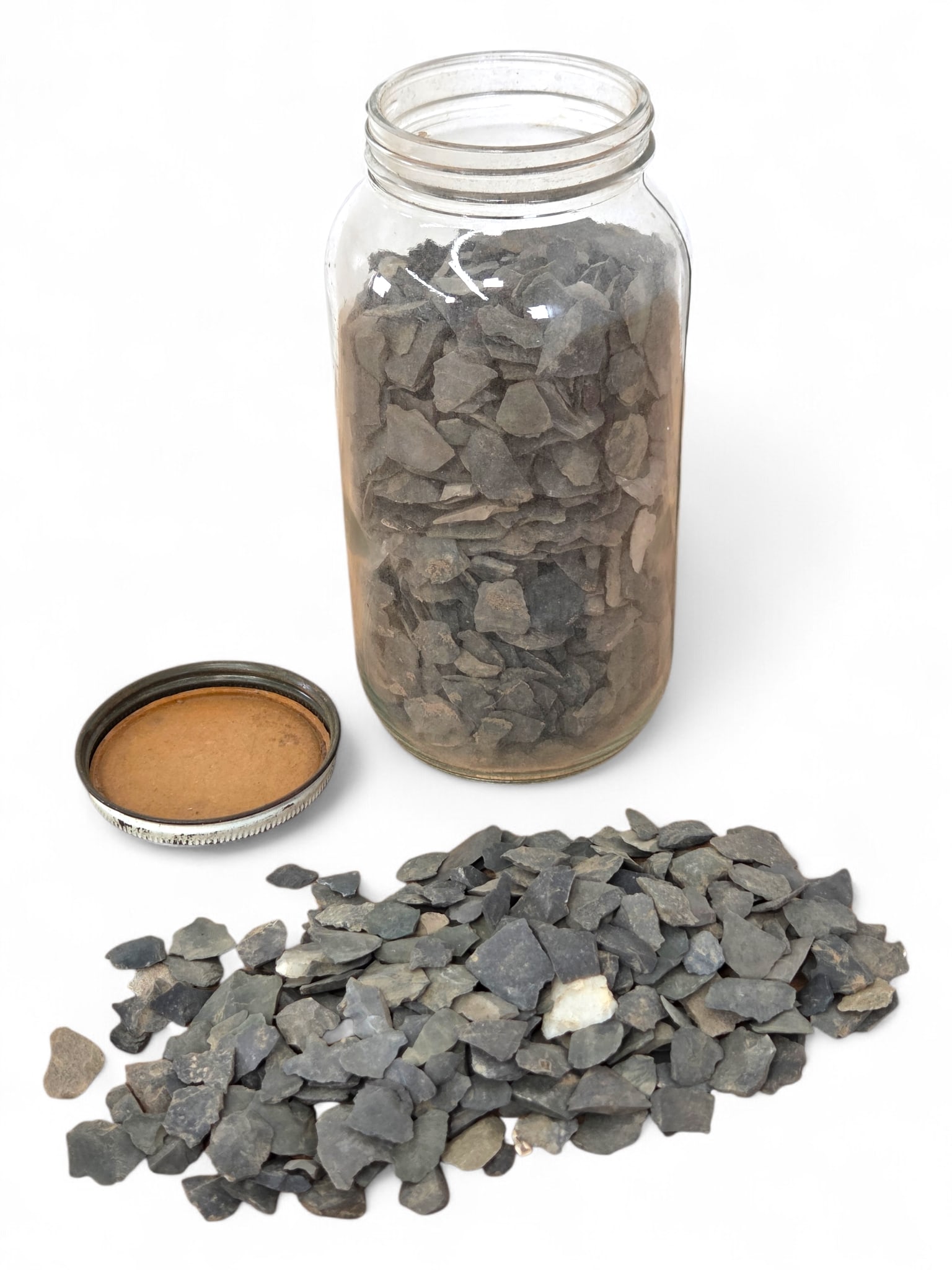 Native American Arrowhead Flakes & Scraps: Jar filled with Native American arrowhead pieces and scraps, most appearing to be flint, See photos for more item and condition details. Jar: 7.25" T 