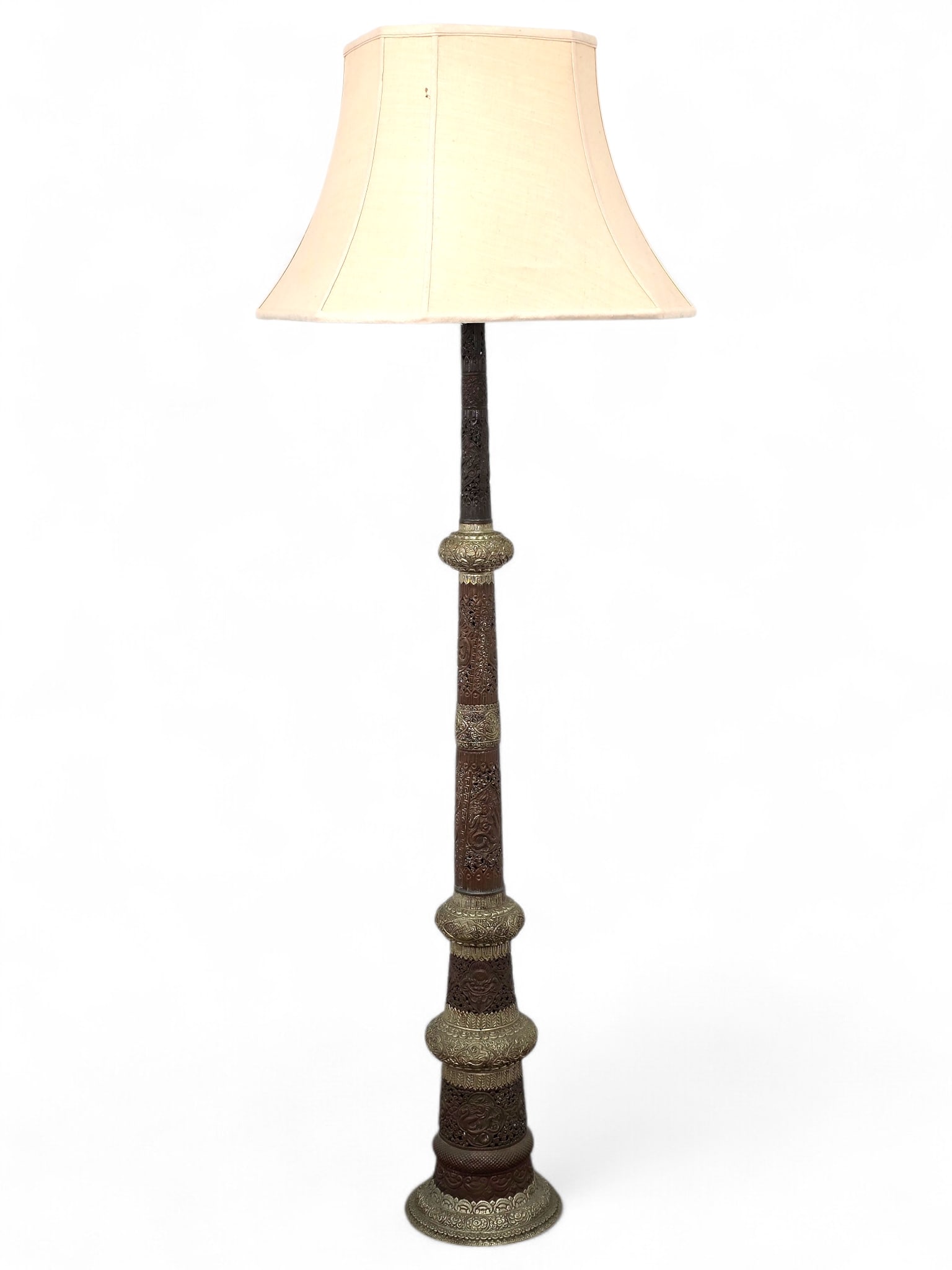 Middle Eastern Style Pierced Brass Floor Lamp:  Middle eastern floor lamp with ornate pierced brass repousse base. The lamp has a double socket and two toned metal design. Fabric shade appears to be newer. Wear consistent with age and use in