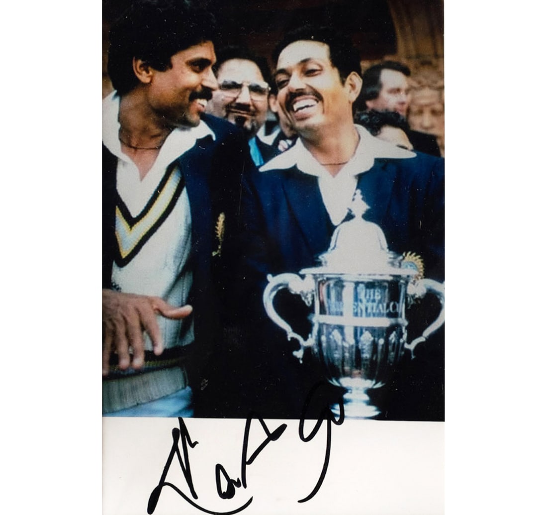 1983 CRICKET WORLD CUP PHOTOGRAPH SIGNED BY KAPIL DEV WITH MOHINDER AMARNATH: Size: 9.5 x 14.5 cm (3.7 x 5.7 Inches) Mount/Sheet Size: 19.8 x 24.8 cm (7.7 x 9.7 Inches) Hand-signed autograph with marker by Indian Captain Kapil Dev A monumental piece of sporting history with