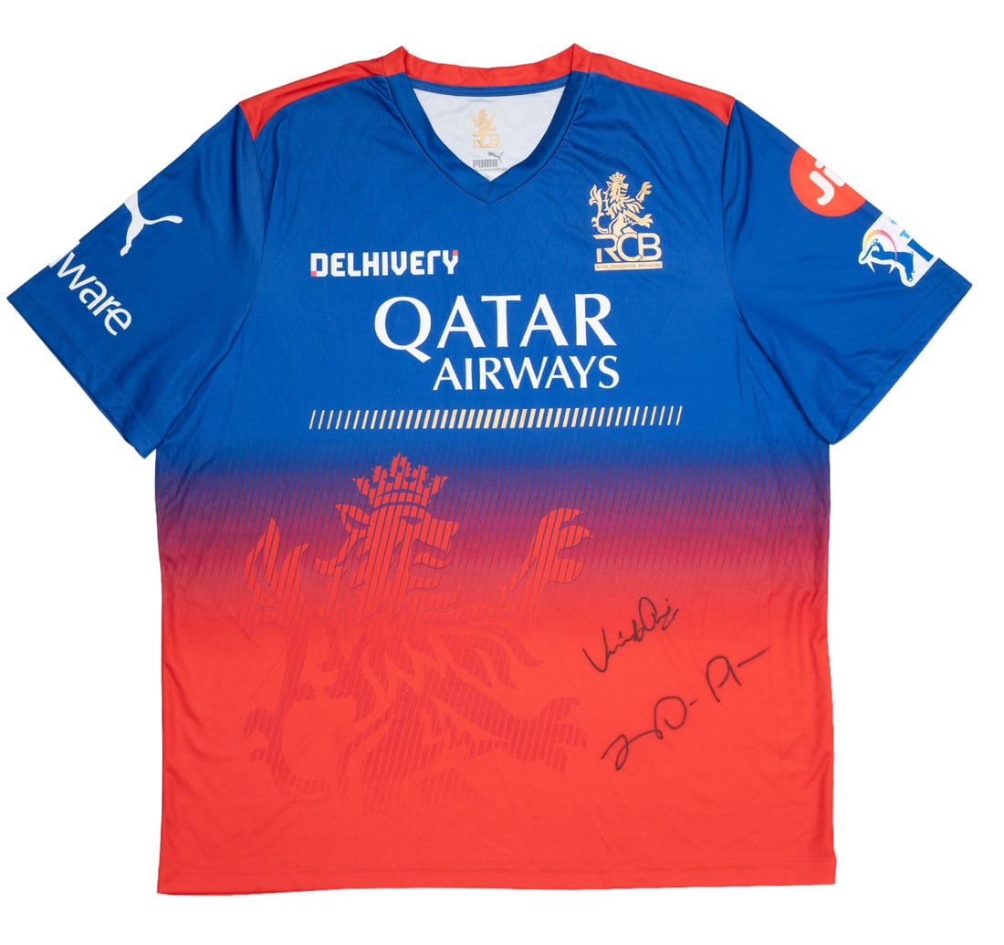 RCB 2024 PUMA FAN EDITION JERSEY WITH TAG SIGNED BY VIRAT KOHLI AND FAB DU PLESSIS: Official 2024 PUMA Fan Edition jersey with original tags. Front dorned with Hand-signed autographs of Virat Kohli and Fab Du Plessis A premier collectible from the "Year of the Champions," this