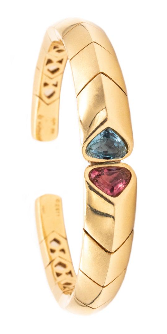 Marina B. Bvlgari Tourmalines & Aquamarines 18k gold: Carefully crafted in solid 18 karats yellow gold with geometric patterns. Bezel set with two rounded trillions cut (10 by 7 by 6 mm) of a natural aquamarine and a pink tourmaline, with a combined weig