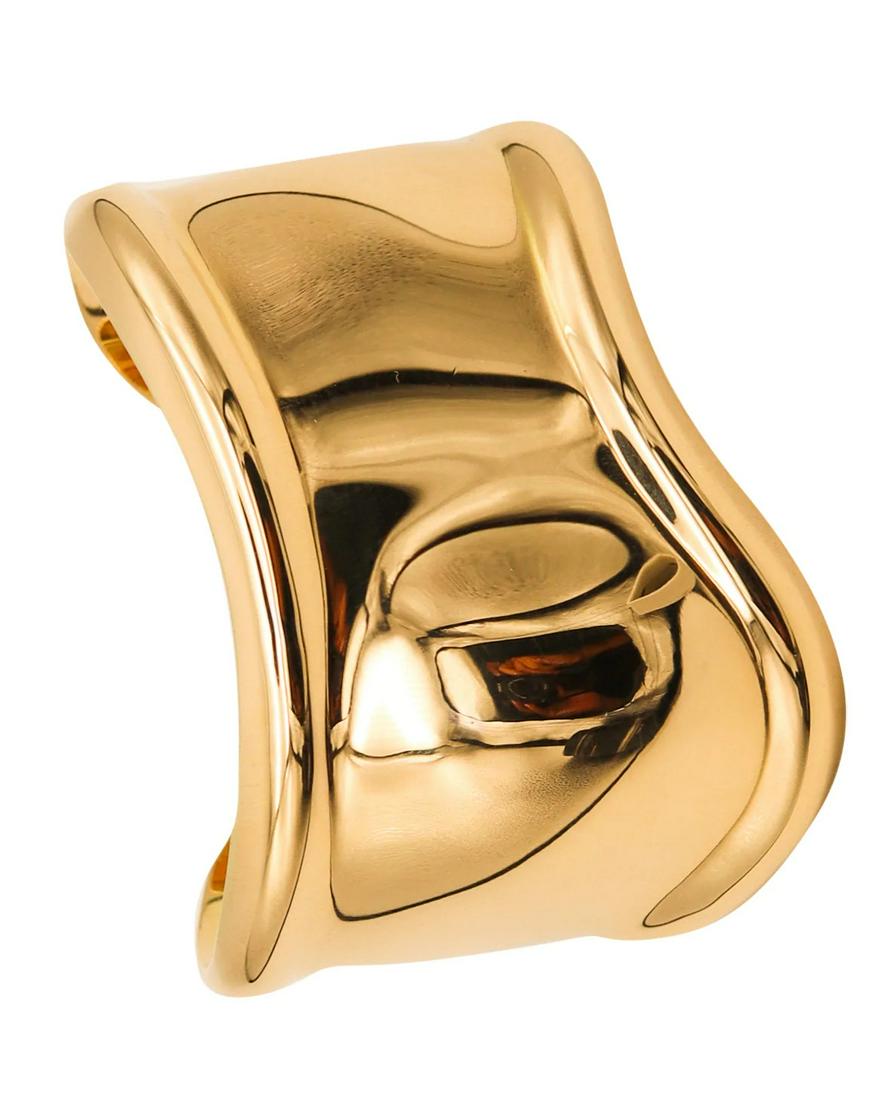 Tiffany Co by Elsa Peretti Rare Small Right Bone Cuff in 18K Gold: This sculptural cuff is one of the most iconic designs, created by Peretti for the Tiffany studios and from the 20th century. This open side cuff model was originally created in the 1970's and it was 
