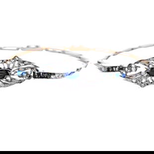 Art deco Bracelet in 18kt Gold and Platinum with Sapphire and Diamonds: Art Deco filigree Bracelet crafted in 18kt yellow Gold and Platinum on top, featuring a center cabochon blue Sapphire Approx 1.00 carats. Accented with 32 Rose cut Diamonds weighing together Approx. 0