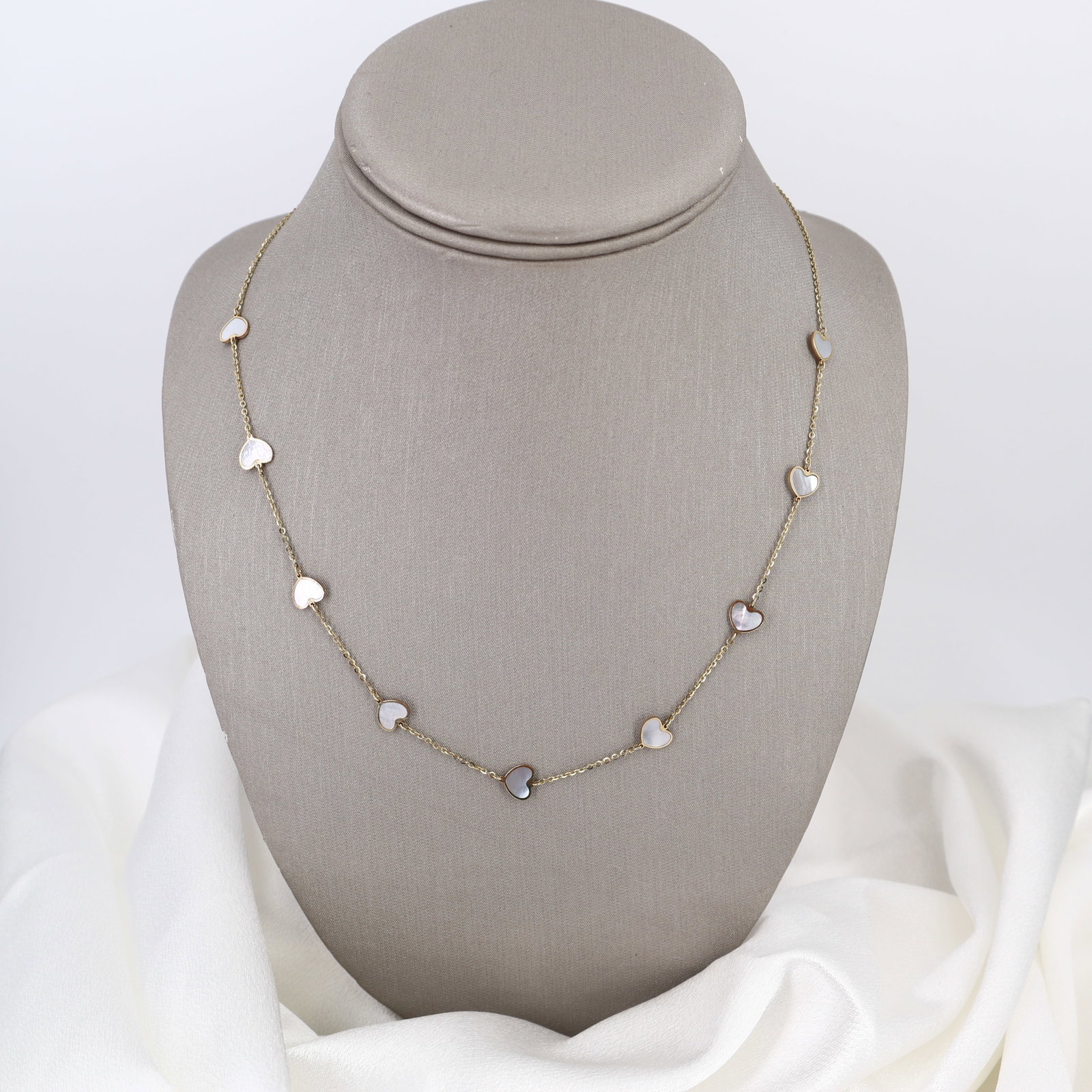 14kt yellow Gold Heart Chain Necklace with Mother of Pearl: Charming 14kt yellow gold chain necklace featuring nine hearts delicately filled with lustrous mother of pearl, creating an elegant and romantic aesthetic. Measuring 17 to 18 inches in length with a t