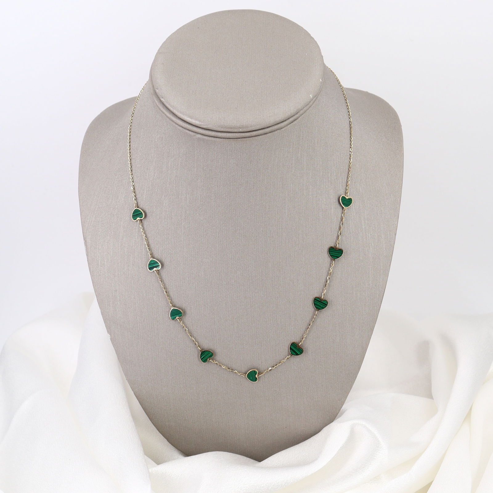 Italian 14kt yellow Gold Heart Chain Necklace with Malachite: Charming 14kt yellow gold chain necklace featuring nine hearts delicately filled with Malachite, creating an elegant and romantic aesthetic. Measuring 15 to 17 inches in length with a total weight of