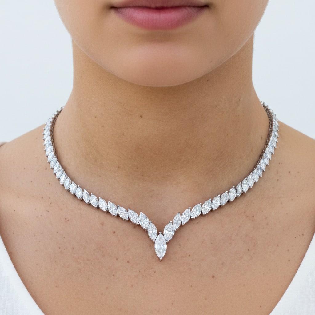 Platinum 32.48 Cts Graduated Diamond Necklace: Platinum graduated diamond necklace featuring 99 marquise-cut diamonds totaling 32.48 carats (J–L color, VS1–SI2 clarity), forming a sleek, high-impact line that culminates in an elegant center dr