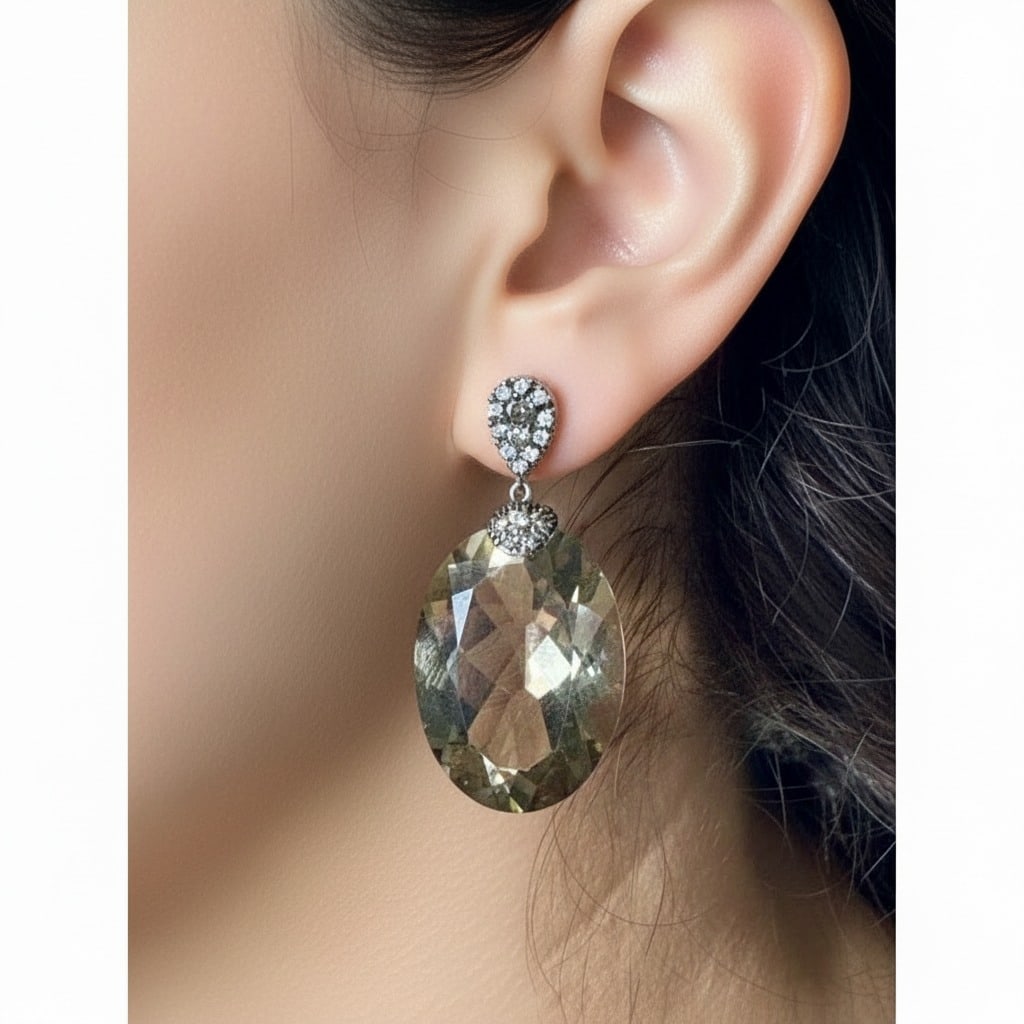 18K Yellow Gold Smokey Topaz & Diamond Earrings: 18K yellow gold smoky topaz and diamond earrings set with two smoky topaz totaling approximately 60.00 carats, accented by 20 white diamonds totaling approximately 0.30 carat (F–G color, VVS–VS cl