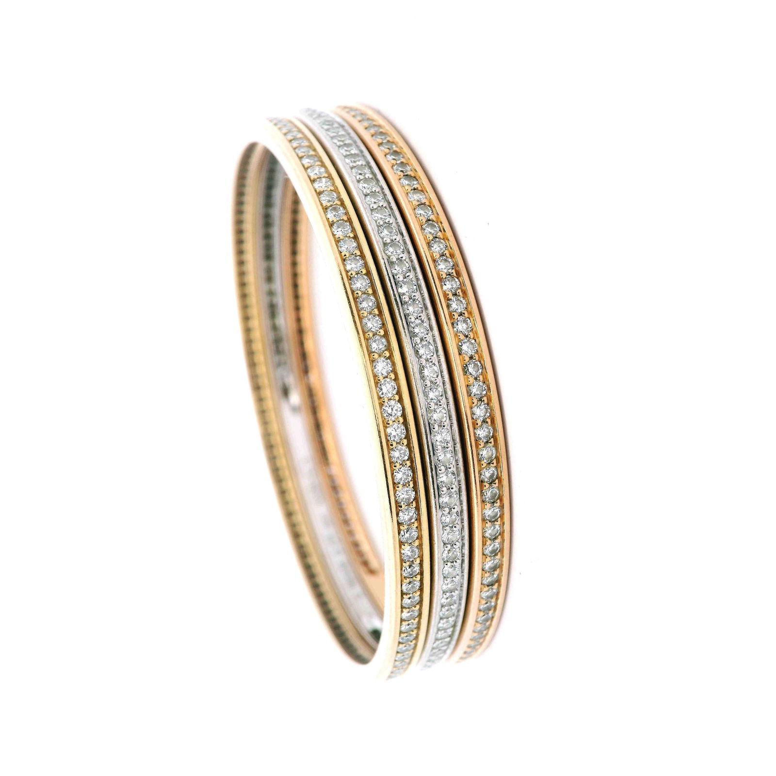 CARTIER Trinity 18kt Gold Bangles with 6.60 Cts in Diamonds: A timeless Cartier classic, this elegant set of three fully rounded bangles is crafted in 18kt rose, yellow, and white gold and set with round brilliant-cut diamonds totaling approximately 6.60 carats