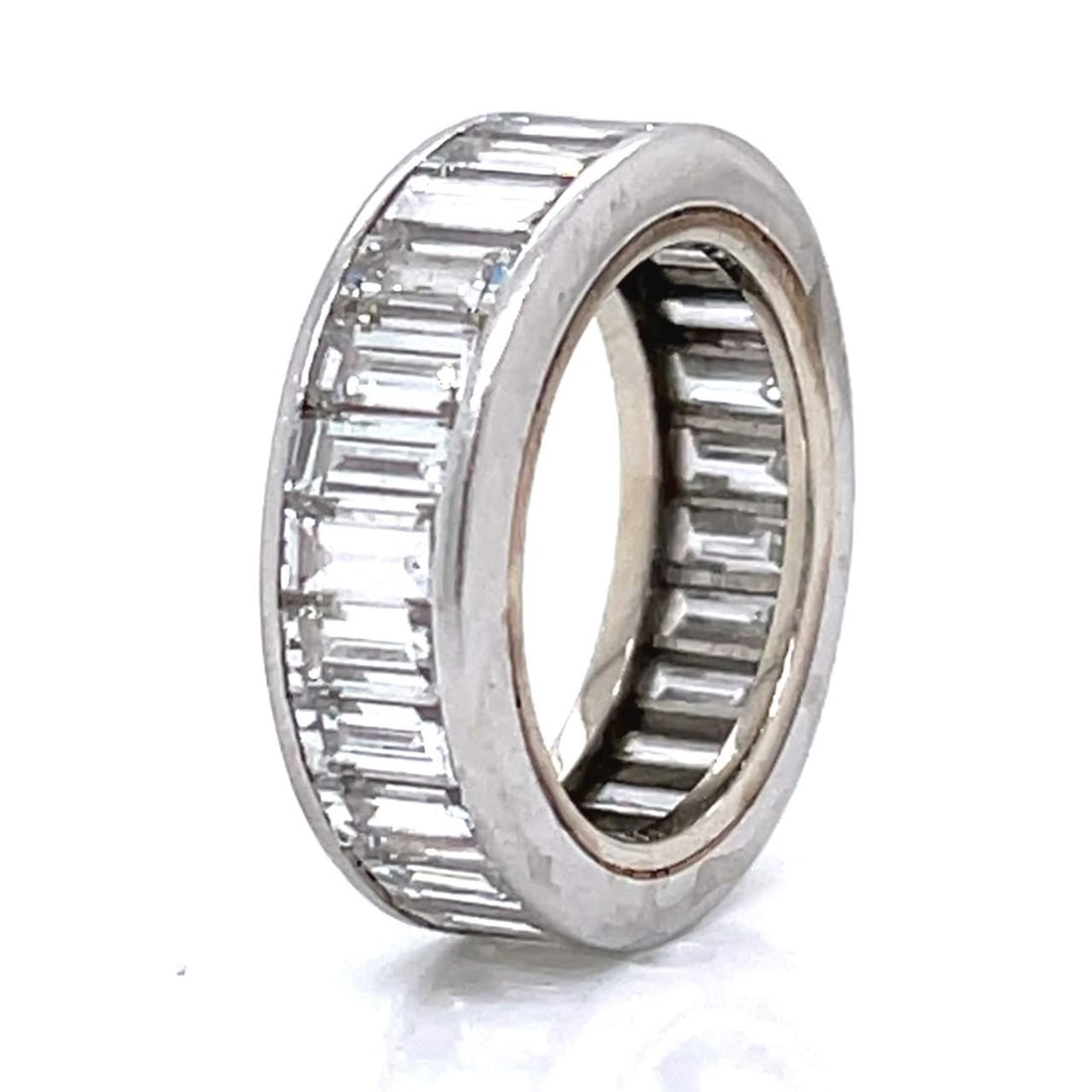 Art Deco Platinum 8.00 Ct. Diamond Eternity Band: Striking Art Deco platinum eternity band, expertly set with 27 baguette-cut diamonds totaling approximately 8.00 carats (G–H color, VVS–VS clarity) for a bold, continuous wall of brilliance. Ring