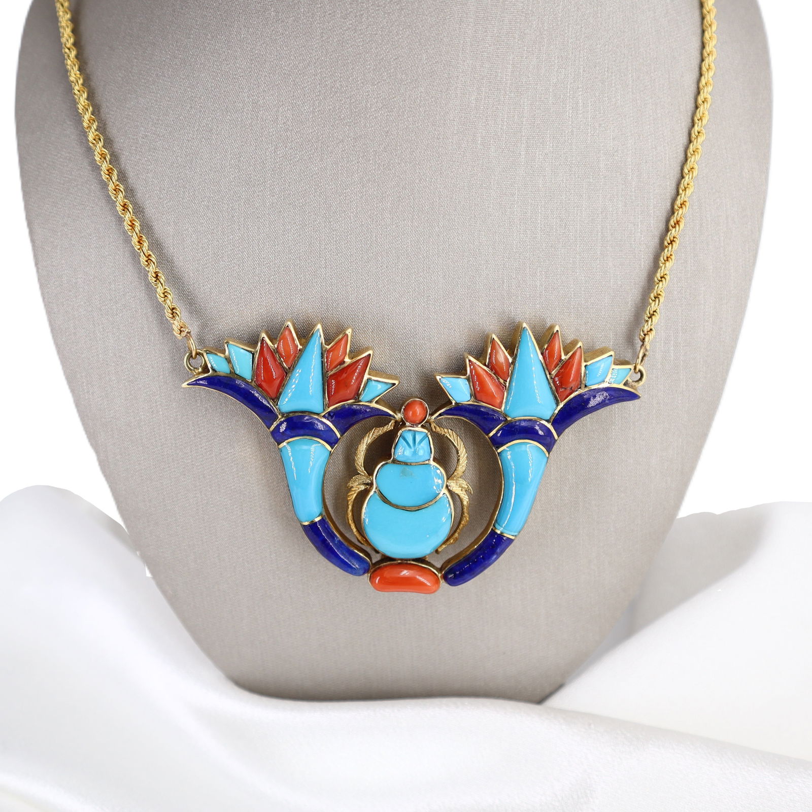 18kt Gold Egyptian Motif Necklace with Turquoises, Lapis Lazuli & Corals: 18kt yellow Gold Egyptian Motif Necklace with a Large Egyptian motif Pendant. It consists of Winged style scarab set with cabochon cut and Inlaid Turquoises, Lapis Lazuli and Corals. Pendant measureme