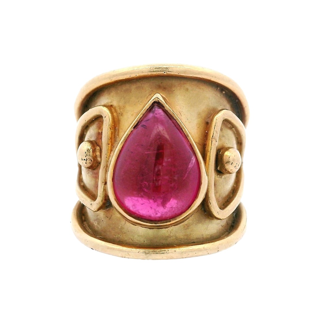 DENISE ROBERGE 18Kt yellow Gold Ring with Pink Tourmaline: Bold ring crafted in 18K yellow gold by DENISE ROBERGE, featuring a vivid pear-shaped pink tourmaline totaling approximately 3.00 carats bezel-set within a wide, sculptural band with raised scroll and