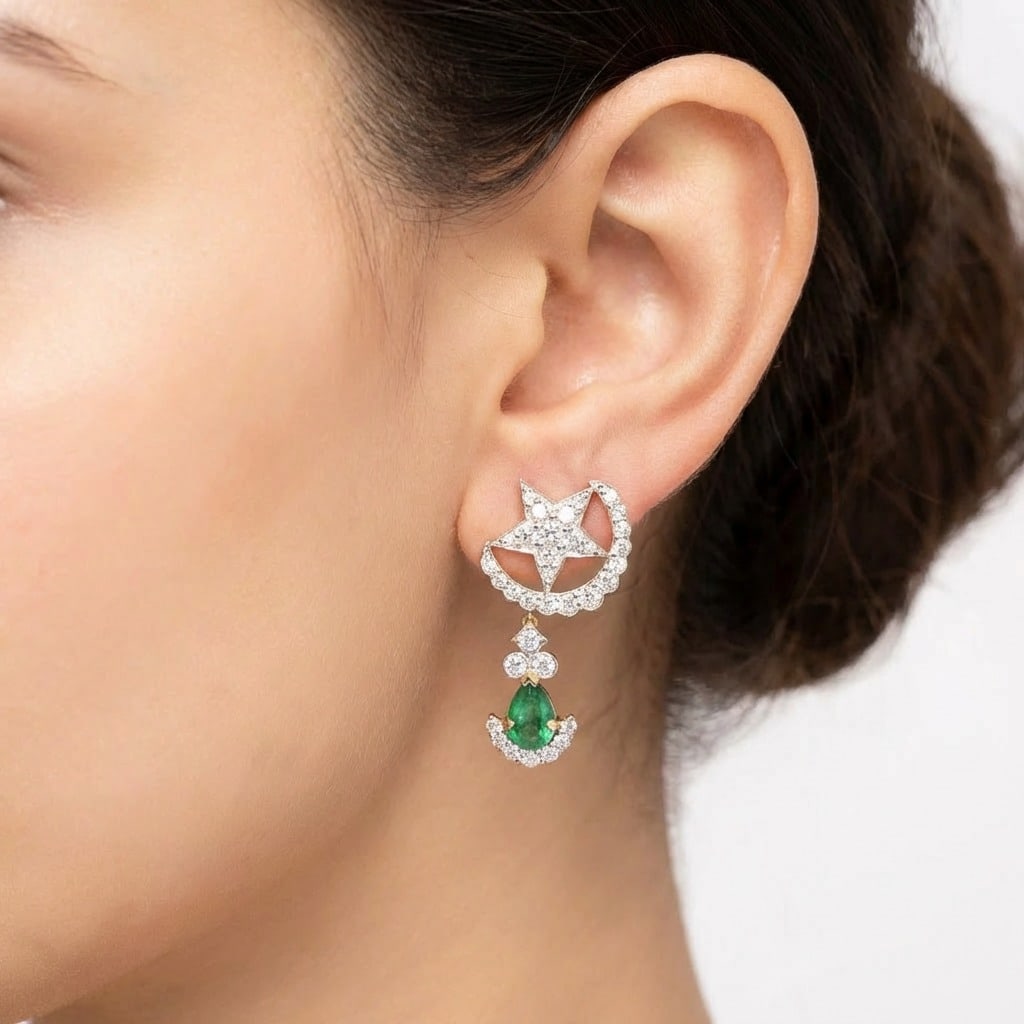 18K Yellow Gold Emerald & Diamond Earrings: 18K yellow gold earrings featuring a whimsical star-and-crescent motif pavéd with 68 diamonds totaling approx. 1.50 ct (G–H color, VS1–SI1 clarity), suspended above 2 vivid emerald teardrop drops