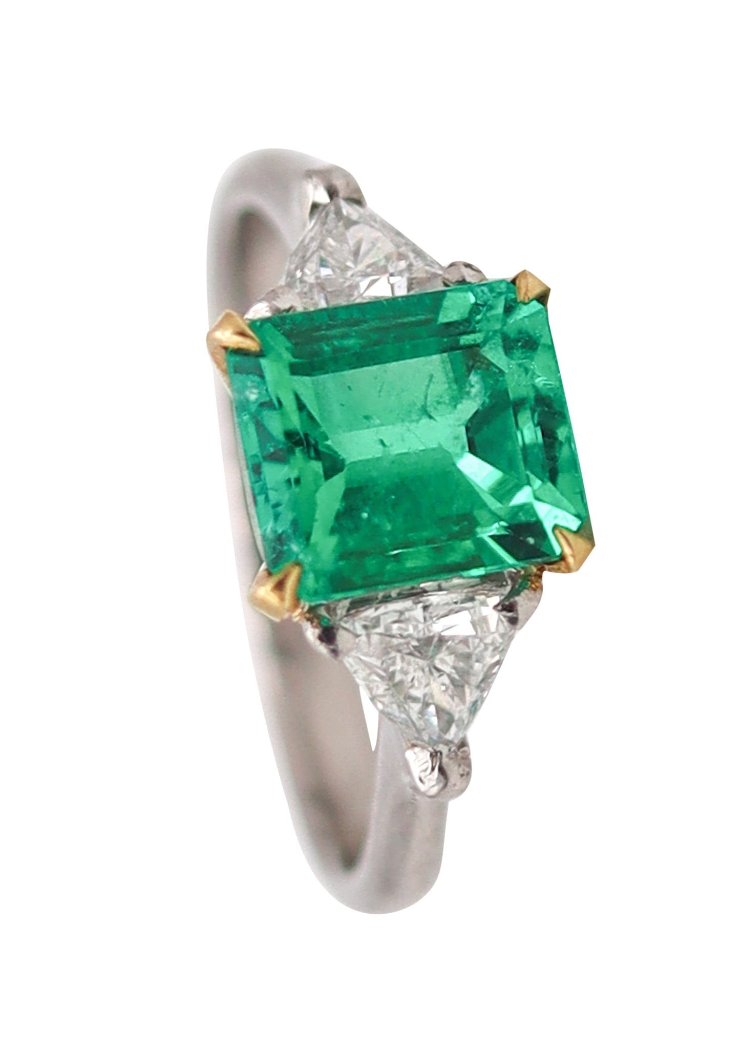 TIFFANY & CO. Ring In Platinum And 18Kt Gold With 2.13 Ctw Emerald & Diamonds: A masterwork of 1990s New York craftsmanship, this Tiffany & Co. three-stone ring pairs platinum and 18K yellow gold with a commanding 1.66-carat Colombian Chivor emerald—vivid and octagonal—flank