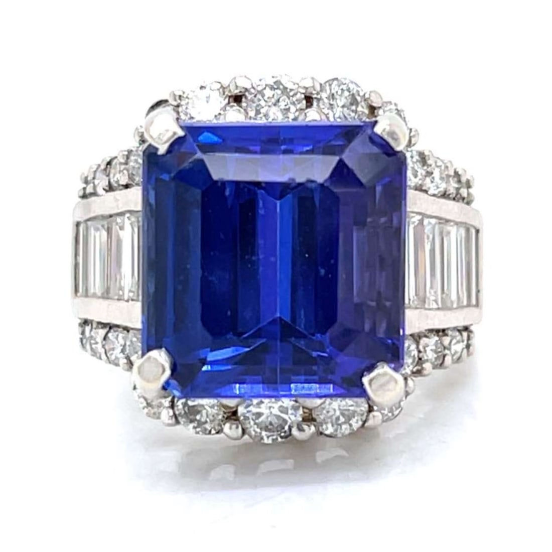 14K White Gold 16.00 Ct. Tanzanite & Diamond Ring: 14K white gold ring showcasing a stunning approx. 16.00 ct tanzanite with brilliant faceting and saturated blue-violet color, flanked by 12 baguette diamonds and surrounded by 26 round diamonds totali
