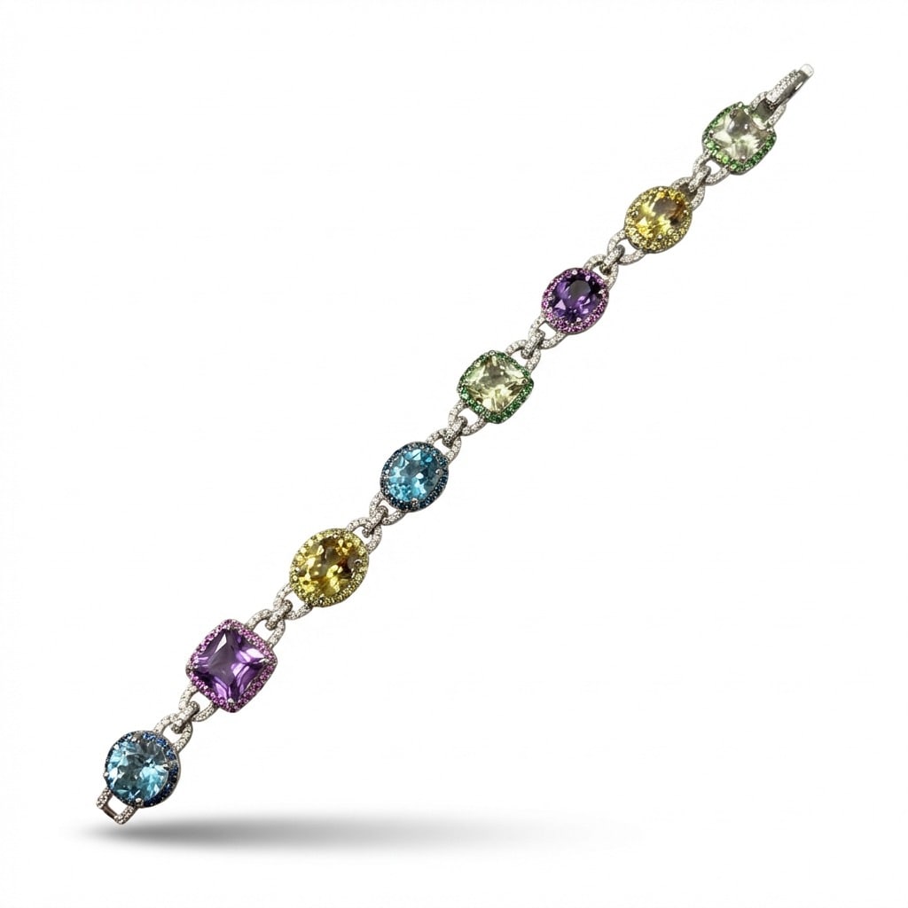 18K White Gold Diamond & Semi Precious Stone Bracelet: 18K white gold bracelet featuring a stunning cascade of approx. 40.00 ct of vibrant semi-precious gemstones, interspersed with diamond-pavéd connectors set with approx. 1.50 ct of diamonds (G–H col