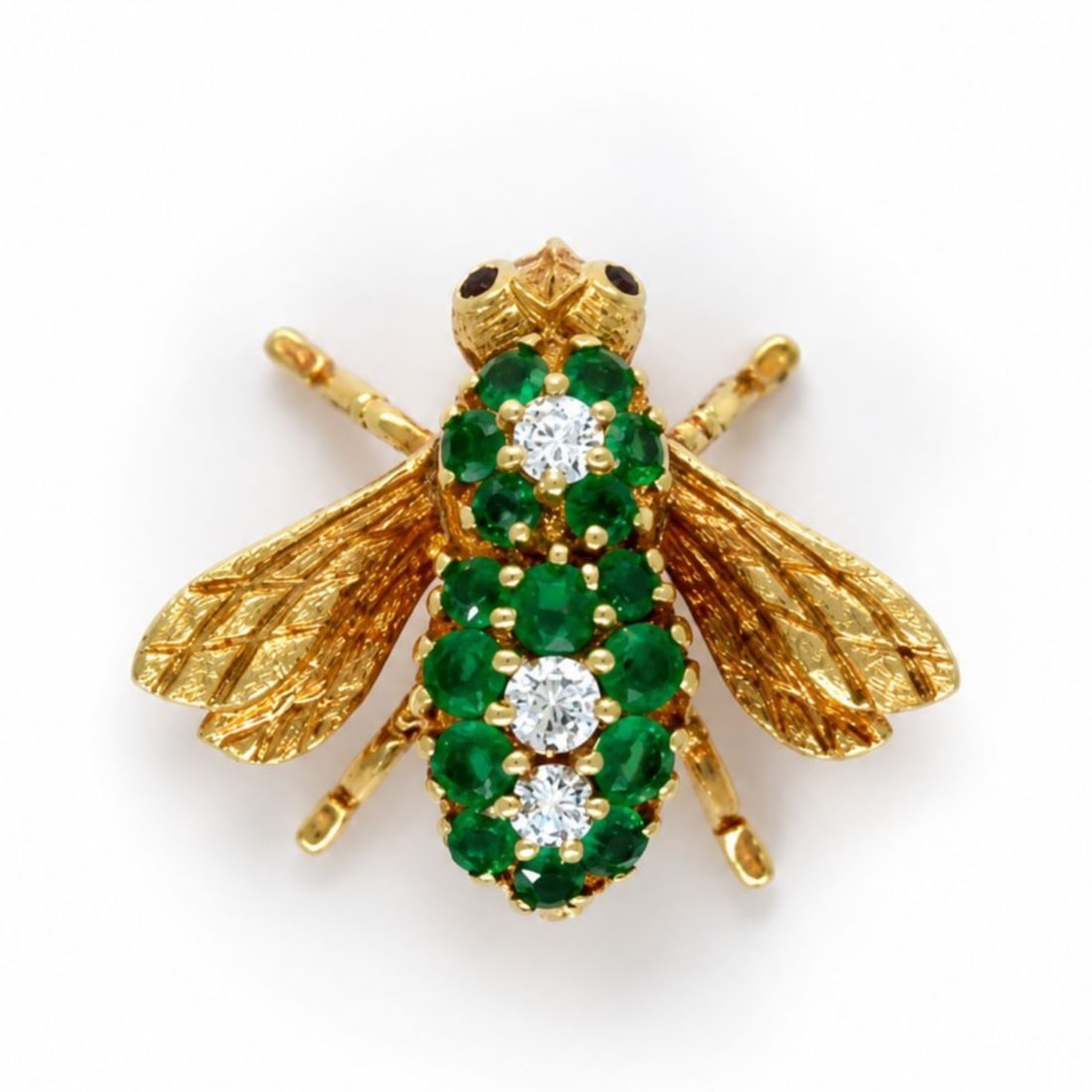 18K Yellow Gold Fly Brooch with 1.00 CTW in Emerald & Diamond: Charming fly brooch crafted in 18K yellow gold, modeled with finely textured wings and articulated legs for a lively, dimensional look. The body is set with 16 vibrant emeralds totaling approximately 