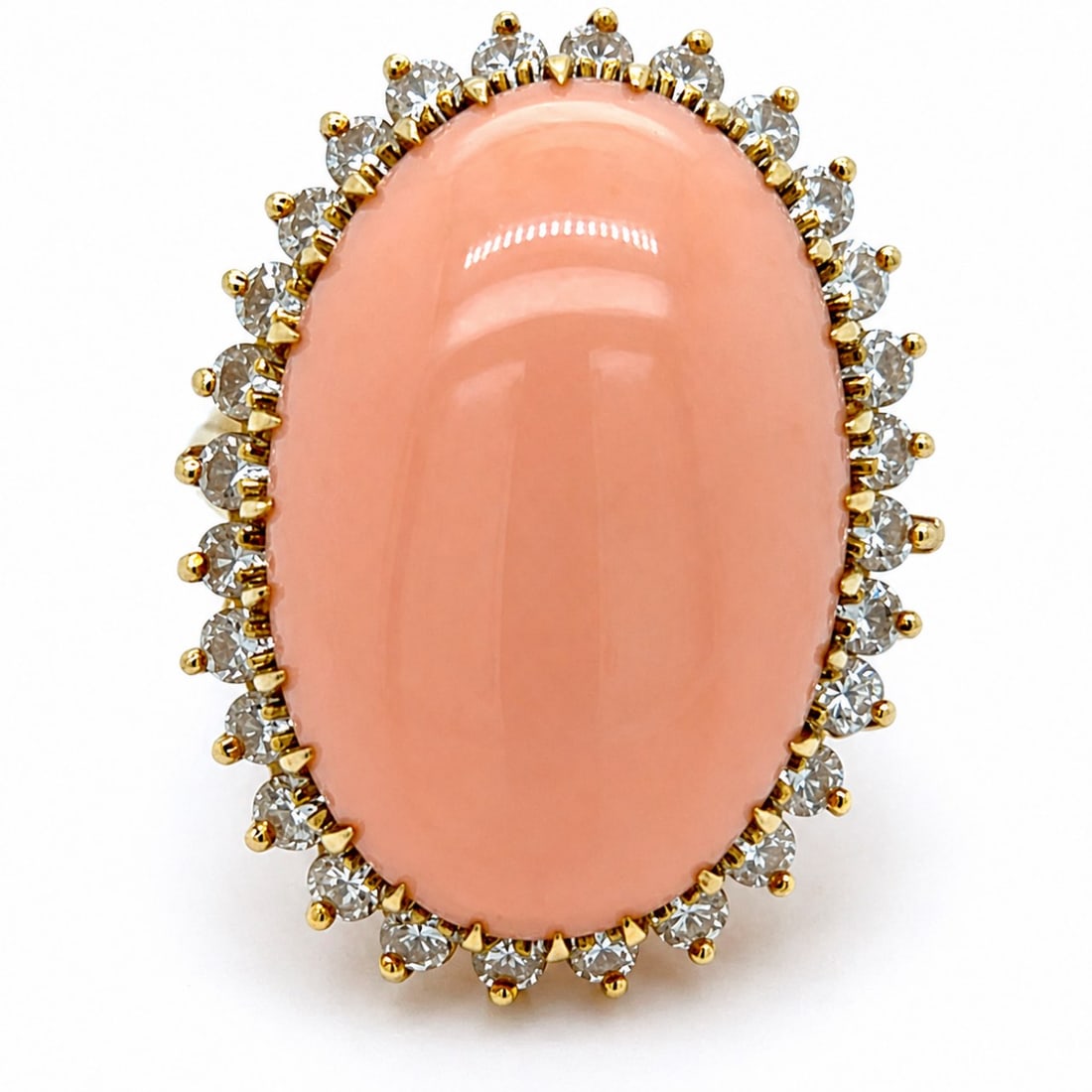 1960s 18K Yellow Gold Coral & Diamond Ring: 1960s 18K Yellow Gold Coral & Diamond Ring, weighing 11.7 grams, showcasing a bold coral cabochon measuring 23.0 x 15.5 mm, framed by 28 diamonds totaling approx. 1.25 cts (G–H color, VVS–VS