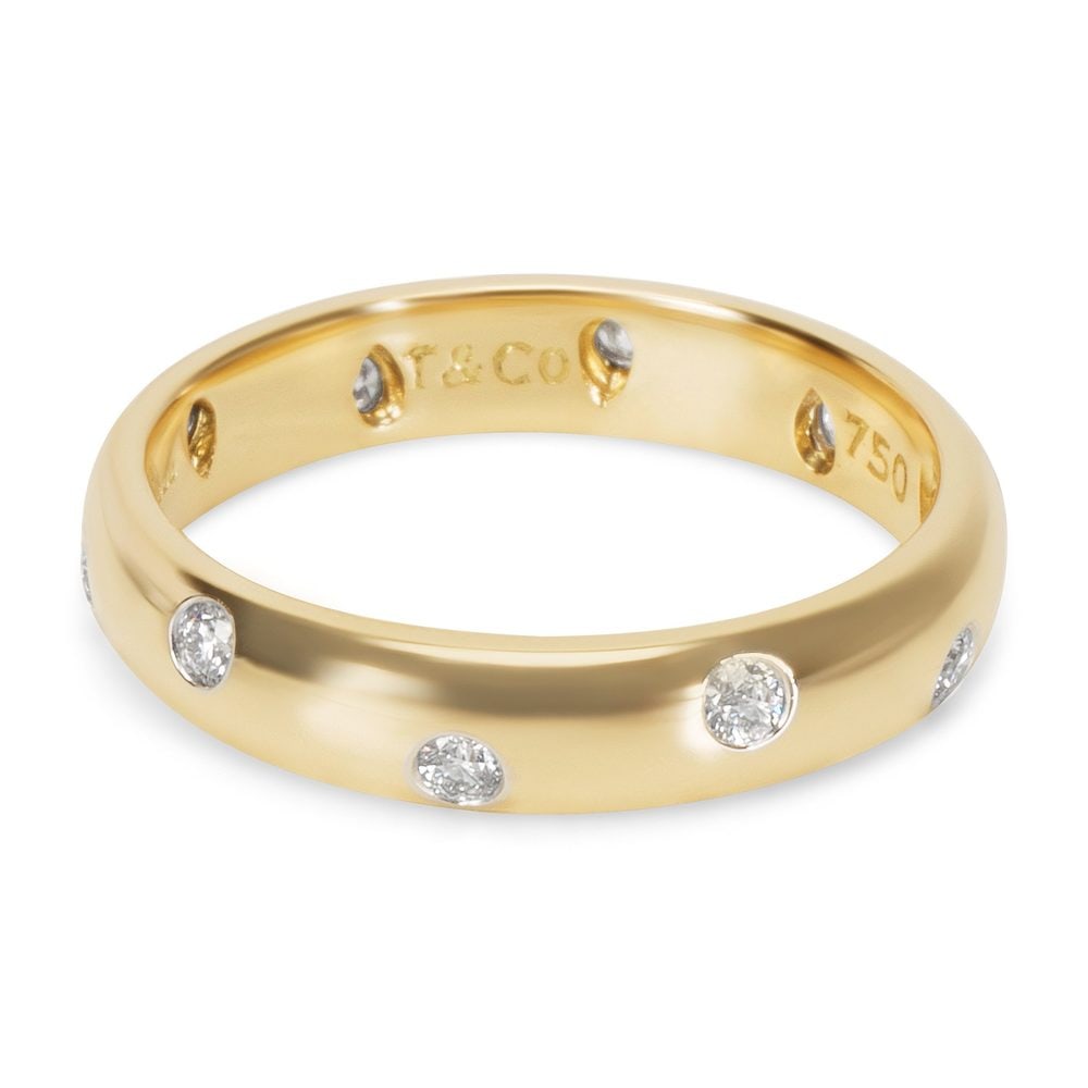 TIFFANY & CO Vintage Etoile 18kt Gold & Platinum Band with Diamonds: Vintage Tiffany & Co band from the Etoile Coolection crafted form 18kt yellow Gold and Platinum. Accenter with 9 Round cut Diamonds weighing together 0.30 carats. F-G color, VS1 clarity. Ring size: 8