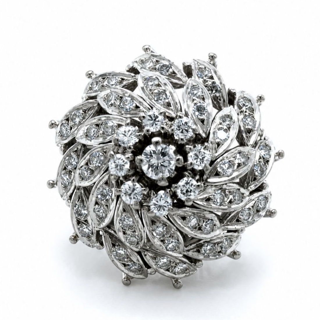 Platinum Ring with 1.00 CTW in Diamond: Elegant 1950s platinum ring designed as a dimensional, floral-inspired cluster, featuring a raised center of bright round diamonds framed by swirling marquise-shaped openwork panels, each pavé-set fo