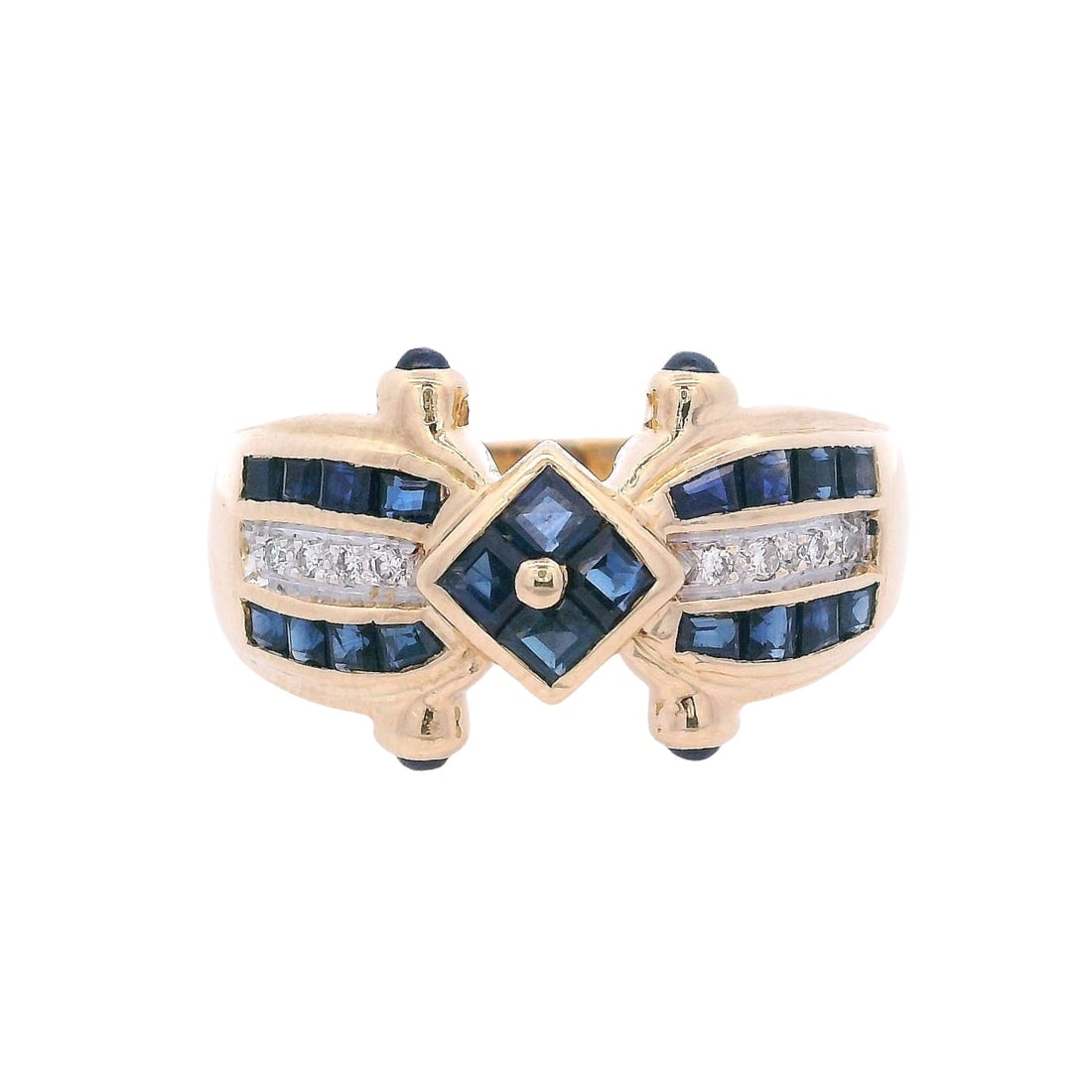 18kt yellow Gold Retro Ring with Sapphires & Diamonds: Retro Ring crafted from 18kt yellow Gold, accenter with square cut and cabochon blue Sapphires of Approx. 0.60 carats. Along with eight Round cut Diamonds weighing Approx. 0.08 carats. Graded colorles