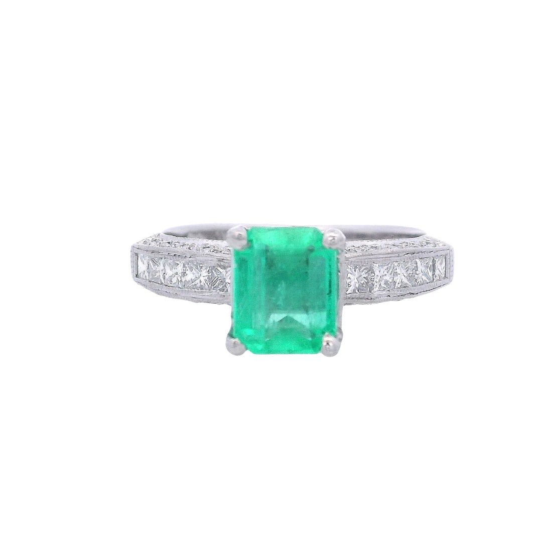 Platinum Ring with 1.85 CTW in Emerald & Diamonds: Platinum Band Ring set with a center Emerald cut Emerald of Approx. 1.15 carats. Accenter with Princess cut and round cut Diamonds weighing together Approx. 0.70 carats. G-H color, VS1 clarity. Ring s