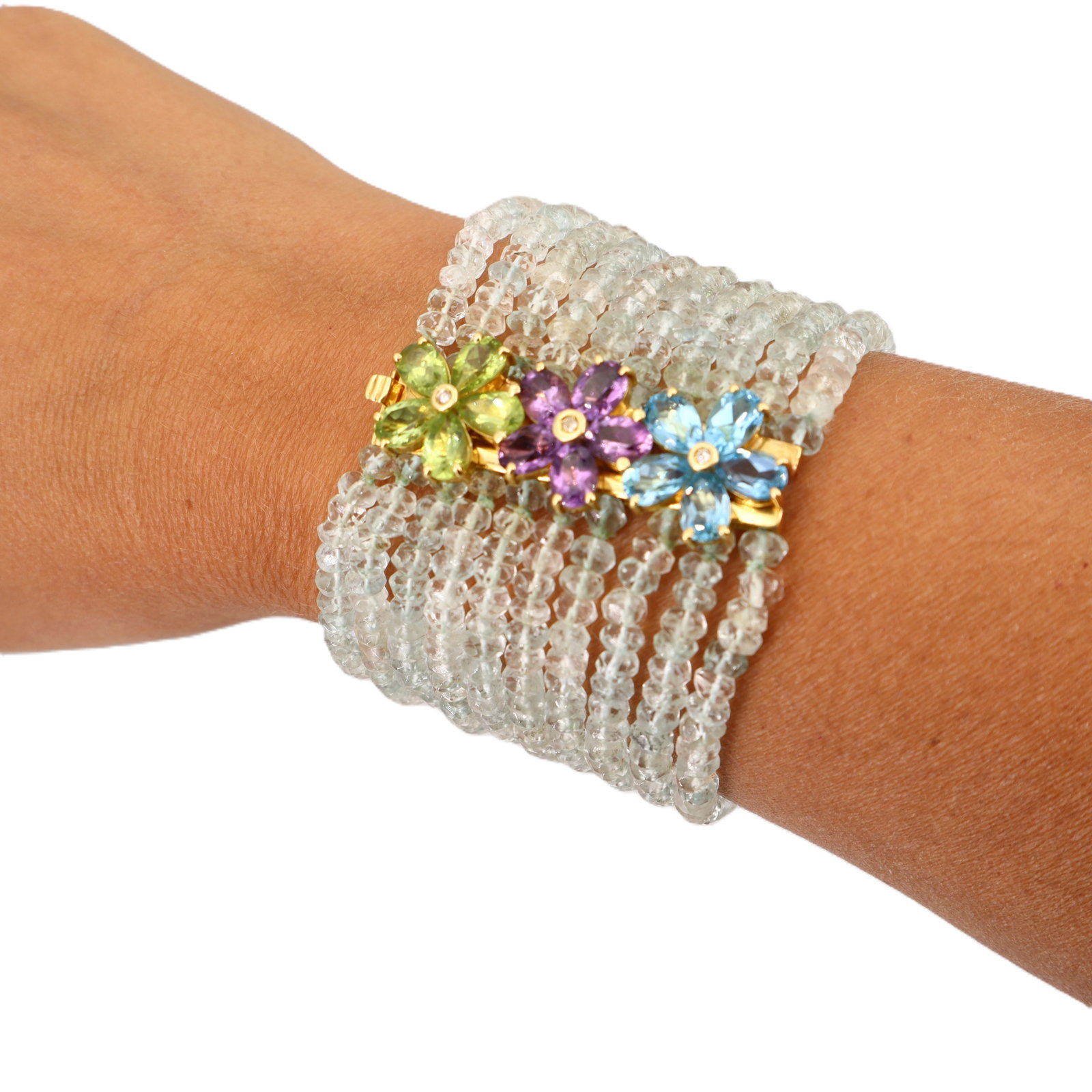 18K Yellow Gold 10-Strand Aquamarine Bead Bracelet w/ Peridot, Amethyst & Blue Topaz: Vibrant and beautifully substantial, this 18K yellow gold multi-strand bracelet features ten strands of aquamarine beads accenter with a colorful mix of semi-precious gemstones, including peridot, ame
