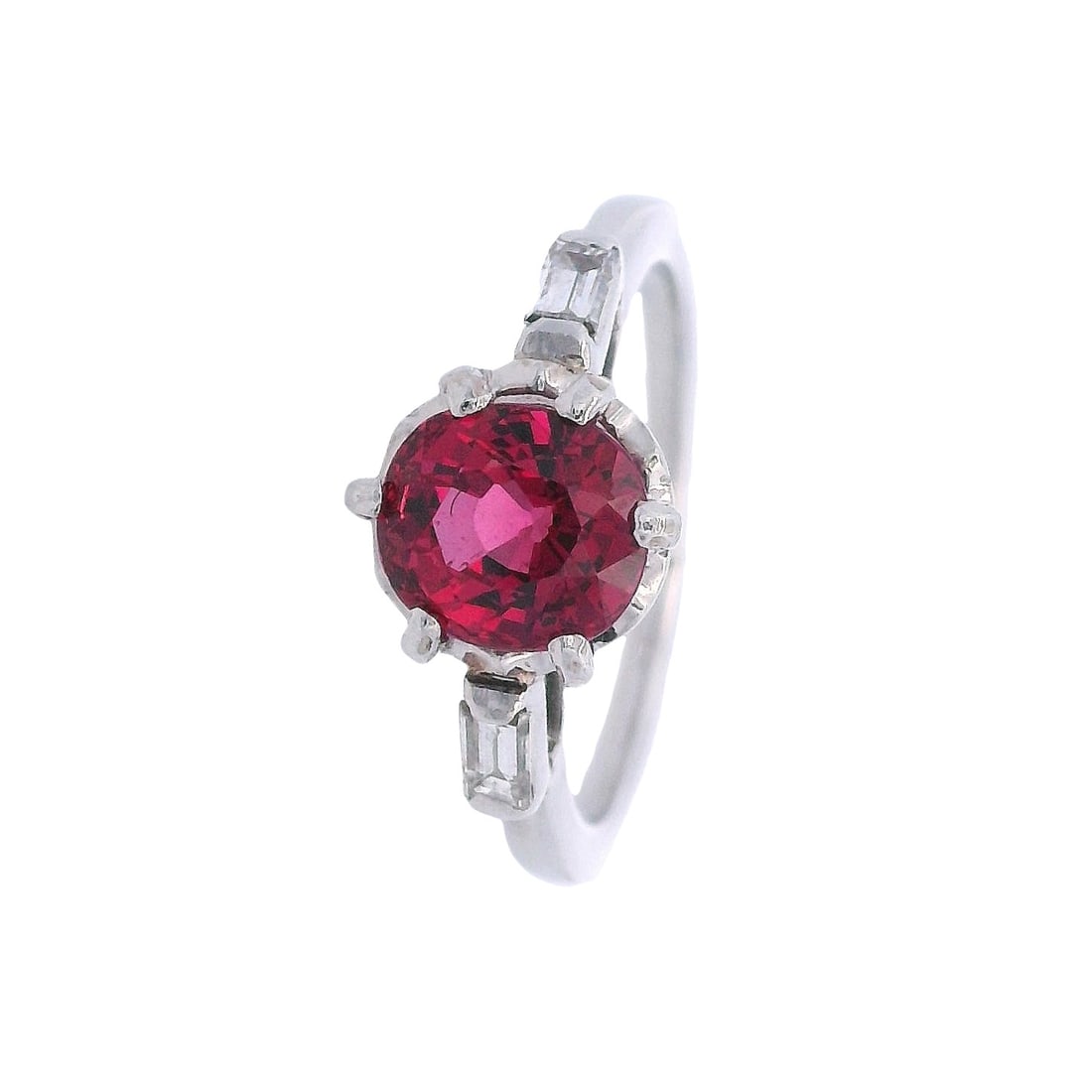 Antique Platinum Red Spinel & Diamonds Ring: Antique Engagement Ring crafted from Platinum, featuring a center Round cut Intense Red Spinel of Approx. 1.30 carats. Along with two Baguette cut Diamonds on the side weighing Approx. 0.20 carats. H 