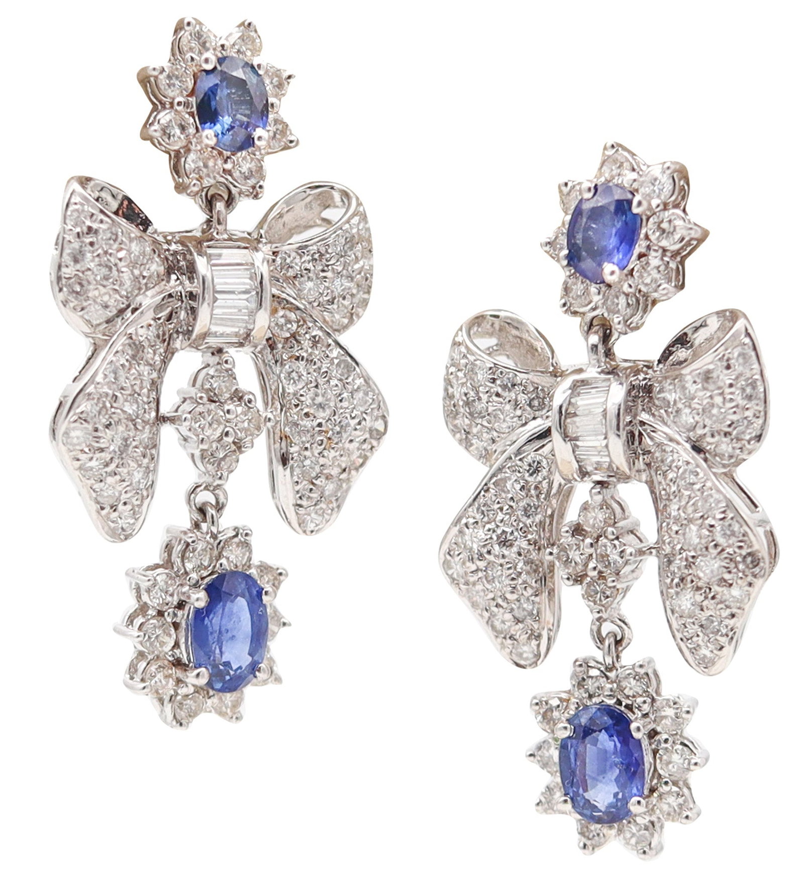1960 Dangle Earrings In 14Kt White Gold With Diamonds & Sapphires: United States, Art Deco design (1930s). Pair of articulated drop earrings in polished 14K white gold, set with 4 oval vivid blue sapphires totaling approx. 1.90 cts, framed by 140 diamonds totaling ap